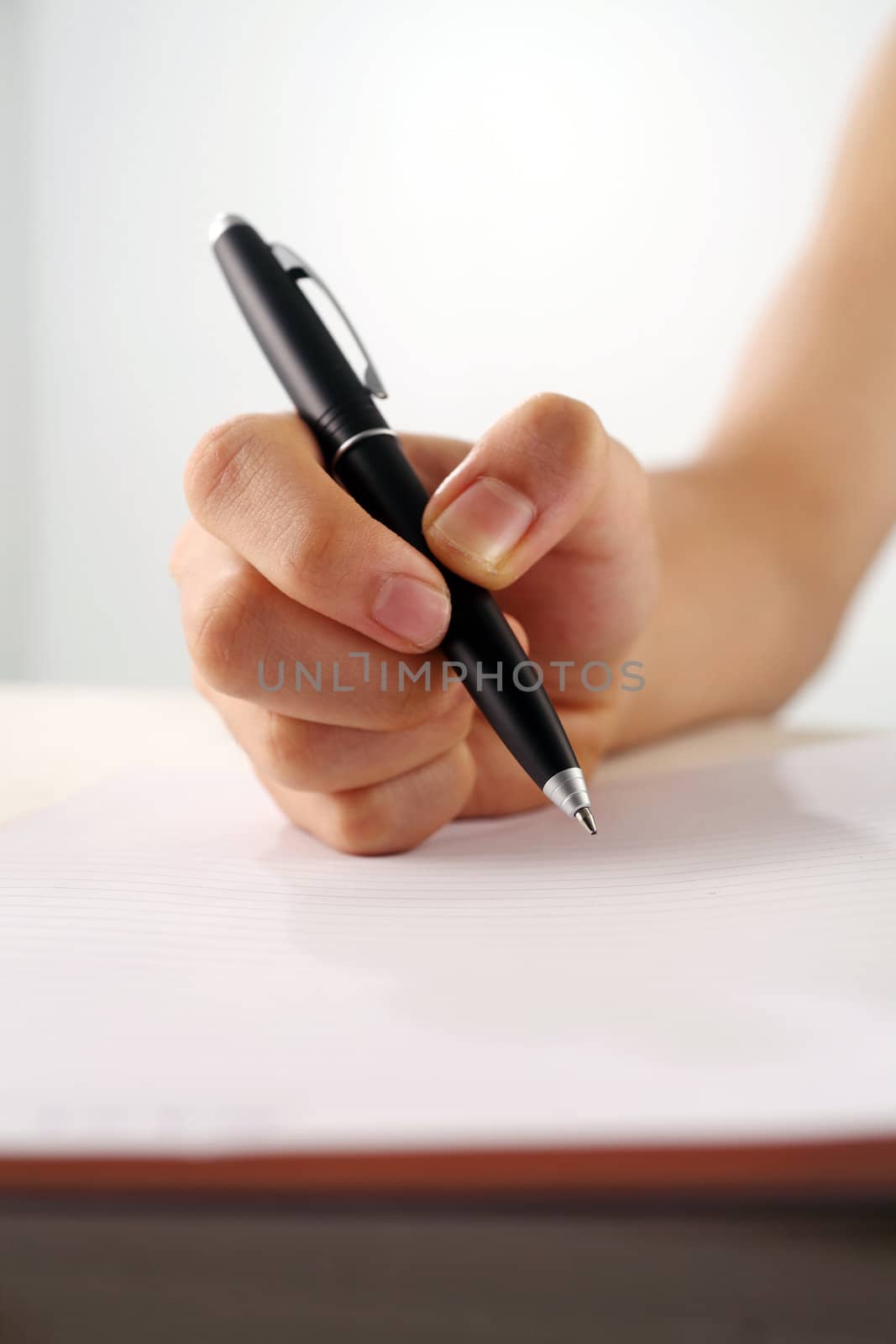 man holding a pen about to write