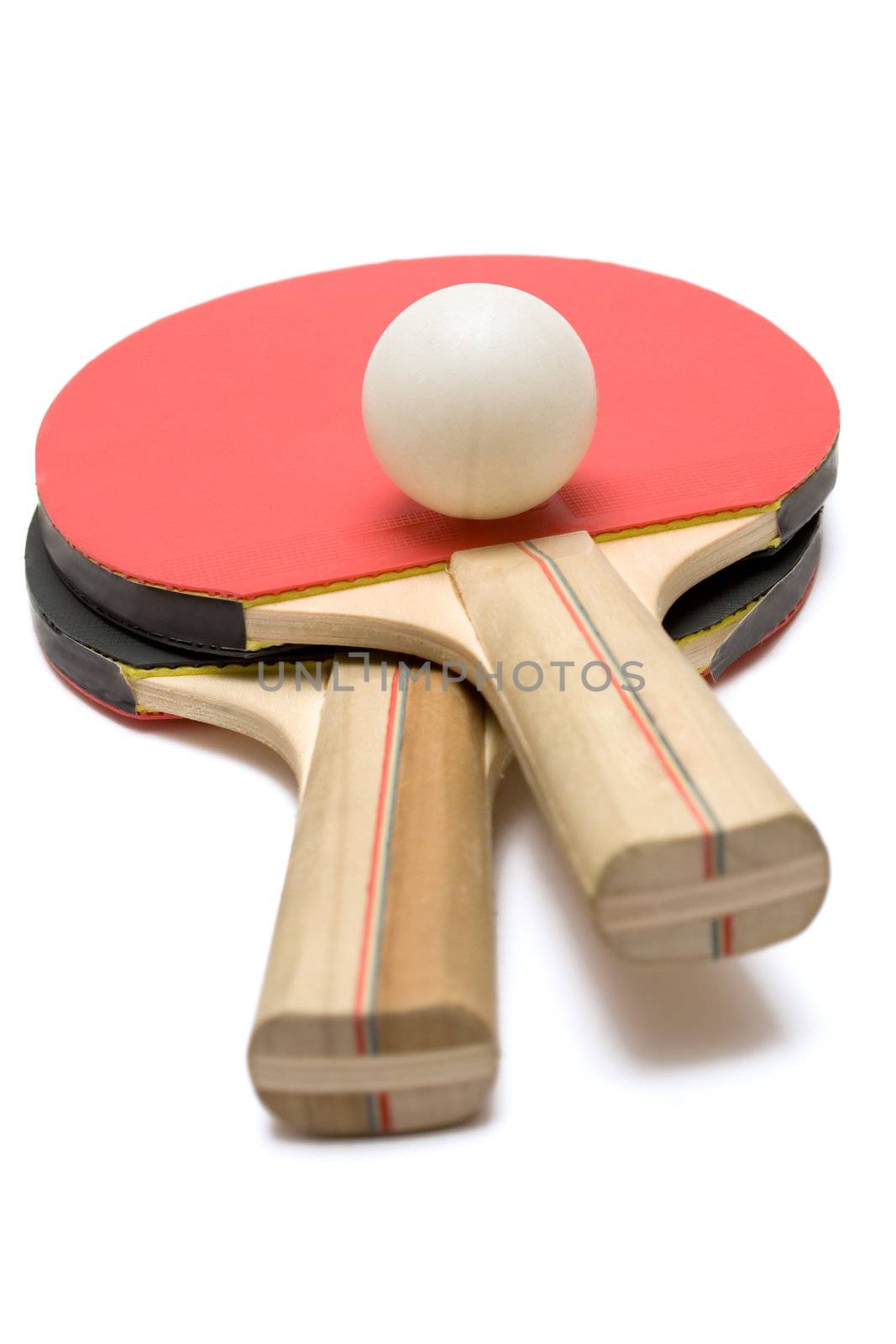Red and black ping pong paddles with ball isolated on a white background.