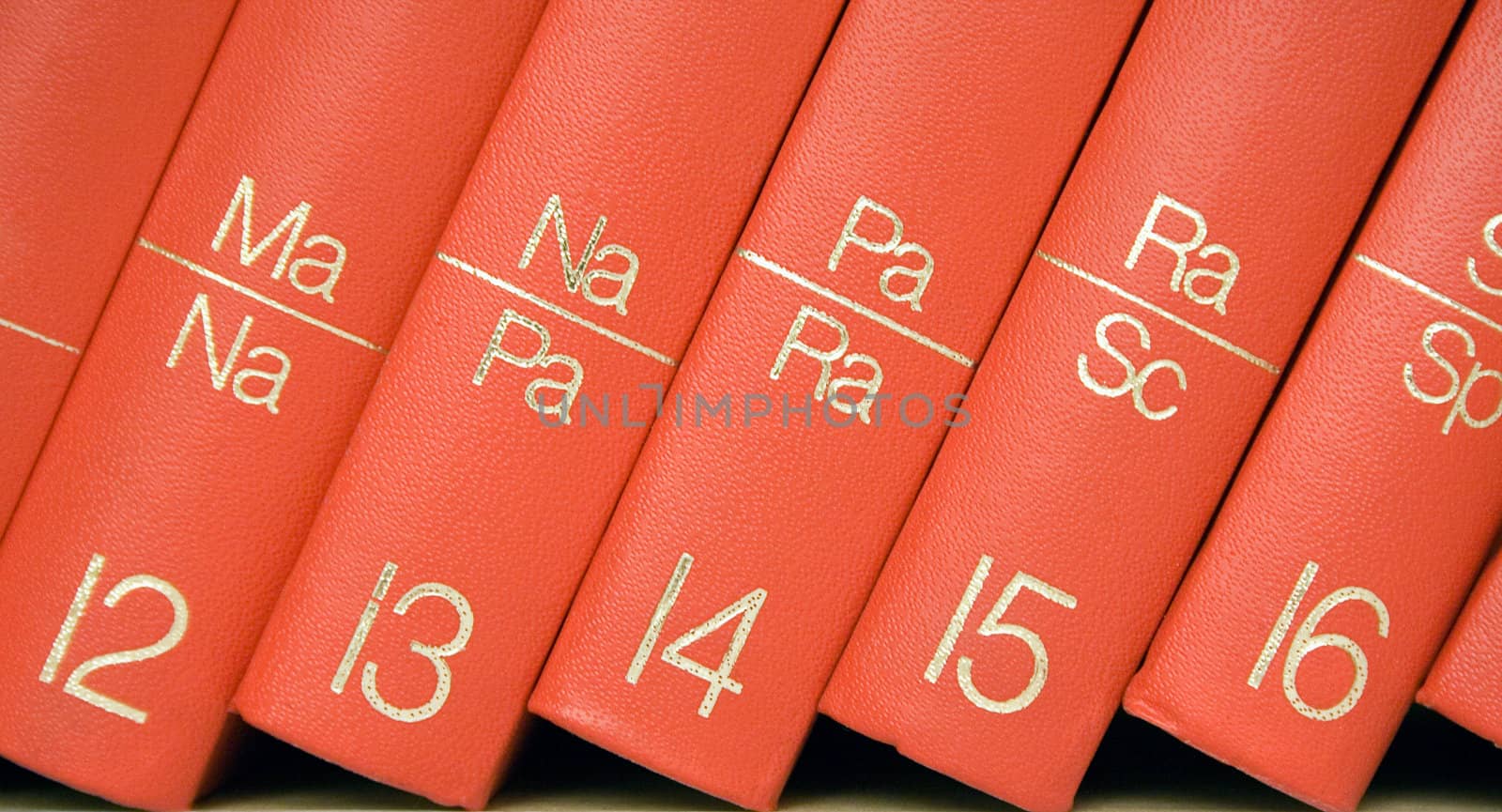 Row of red books in a bookshelf.