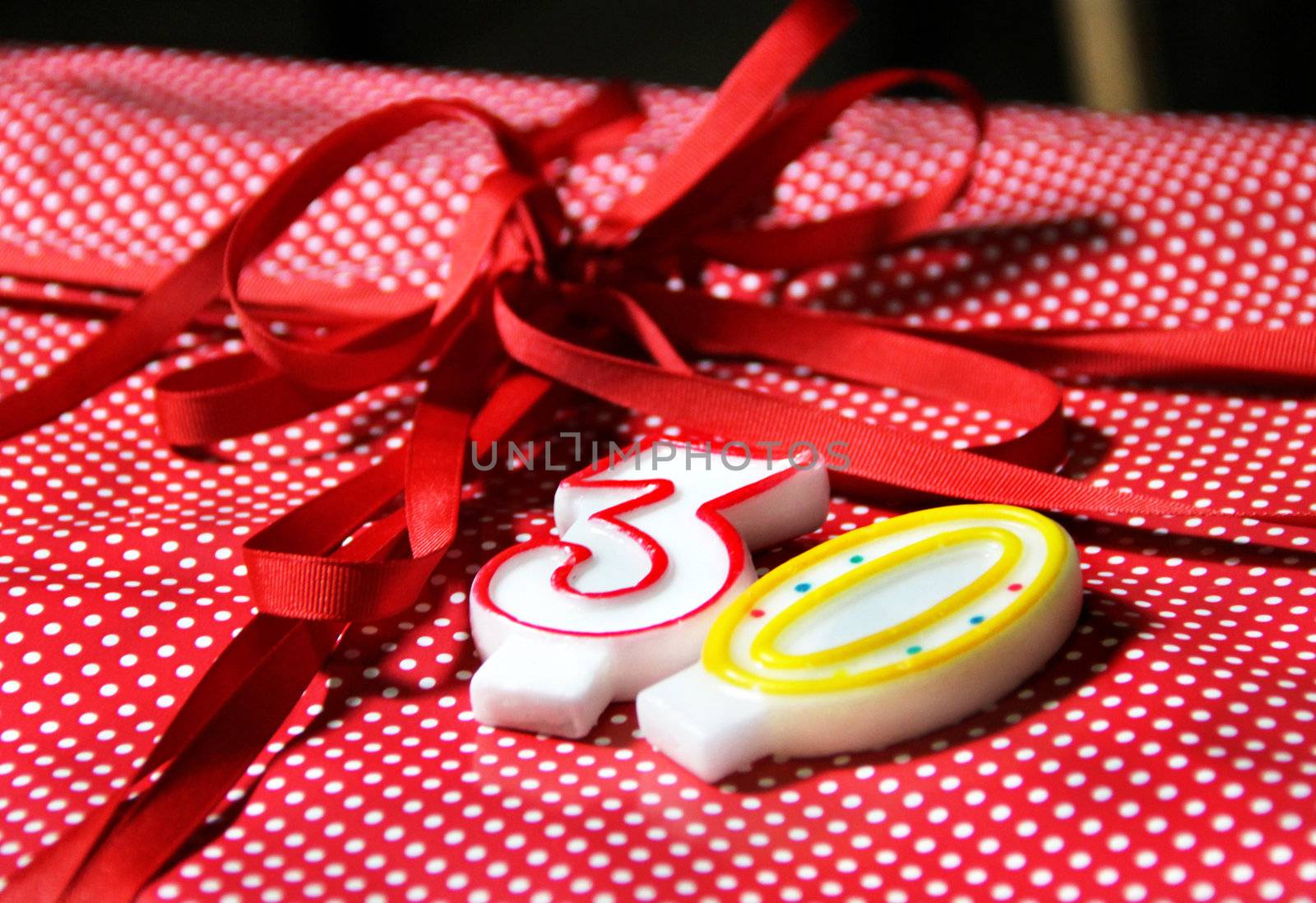 Beautiful present box with red bow and candles