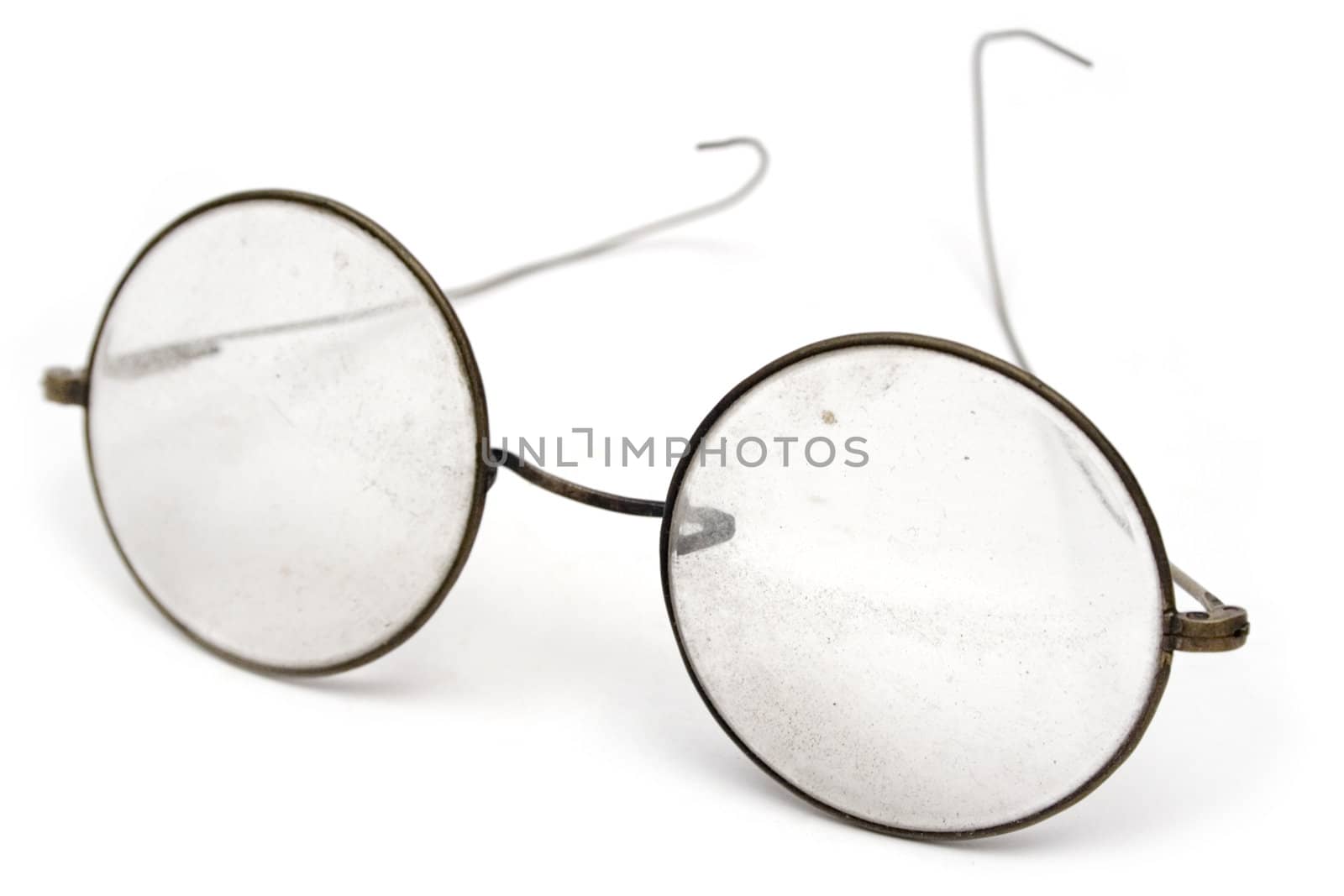 Old and grungy eyeglasses. Isolated on a white background.