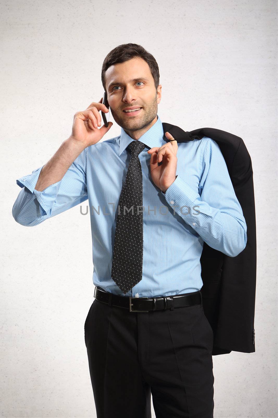 Portrait of young business man using cell phone