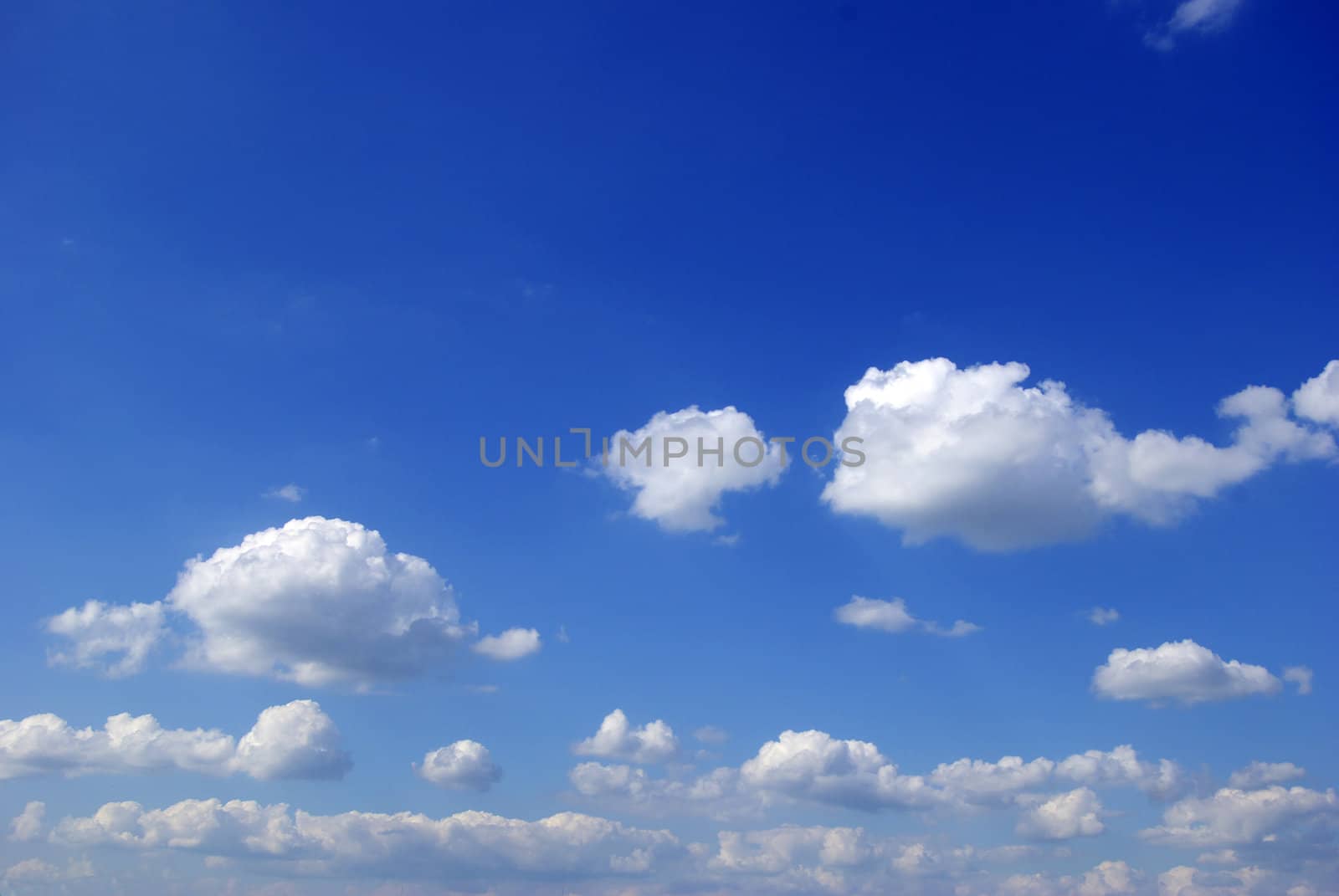 Blue sky background with tiny clouds