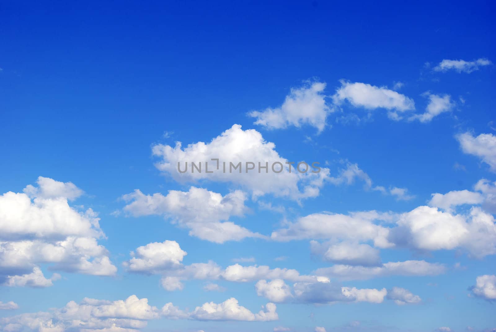 Blue sky background with tiny clouds