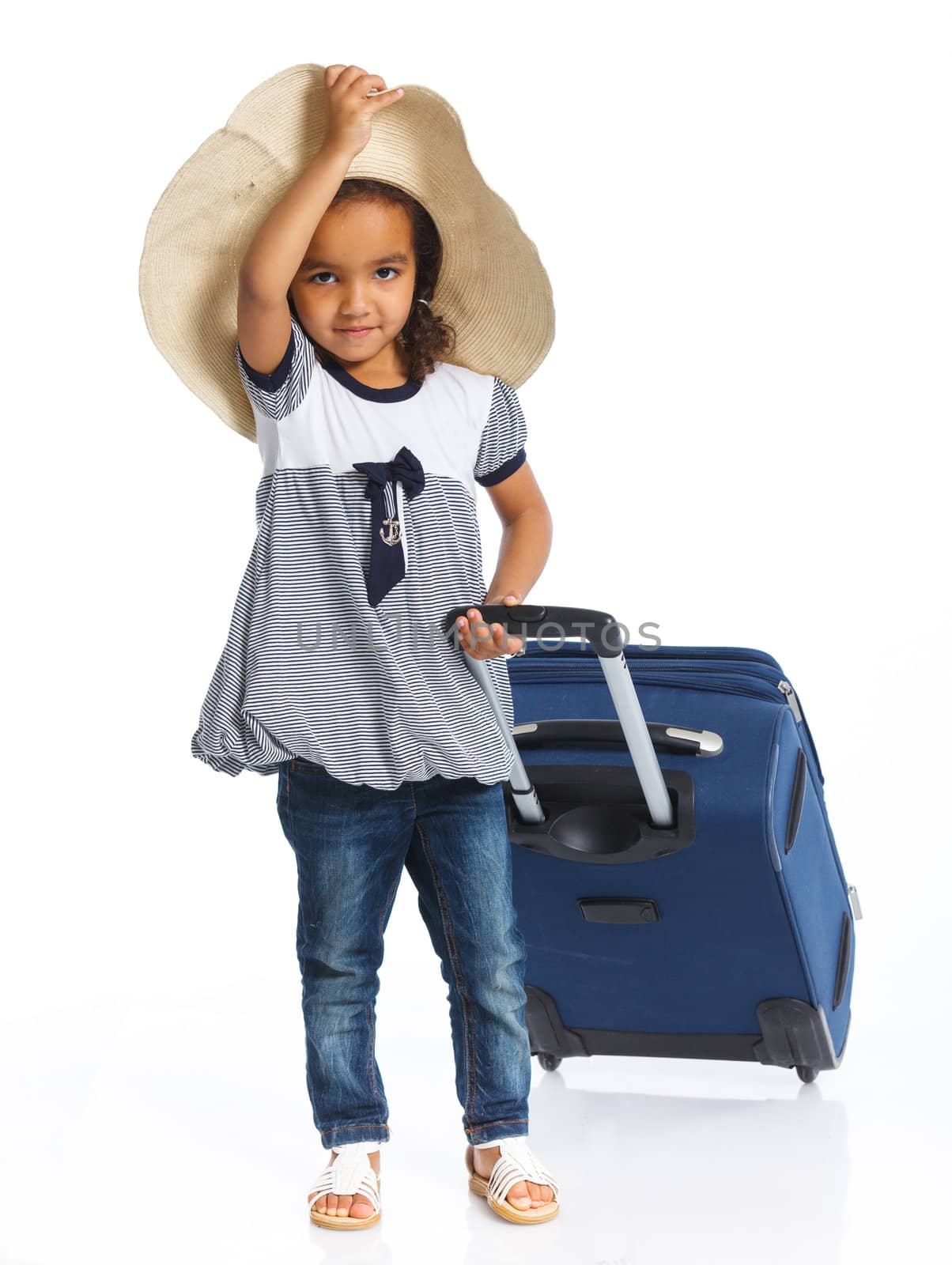The young mulatto traveler girl with hat and a suitcase. Isolated over white background. Vertical view