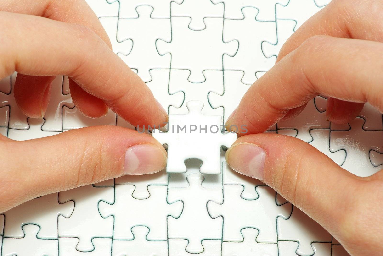 hands holding a puzzle piece . business concepts