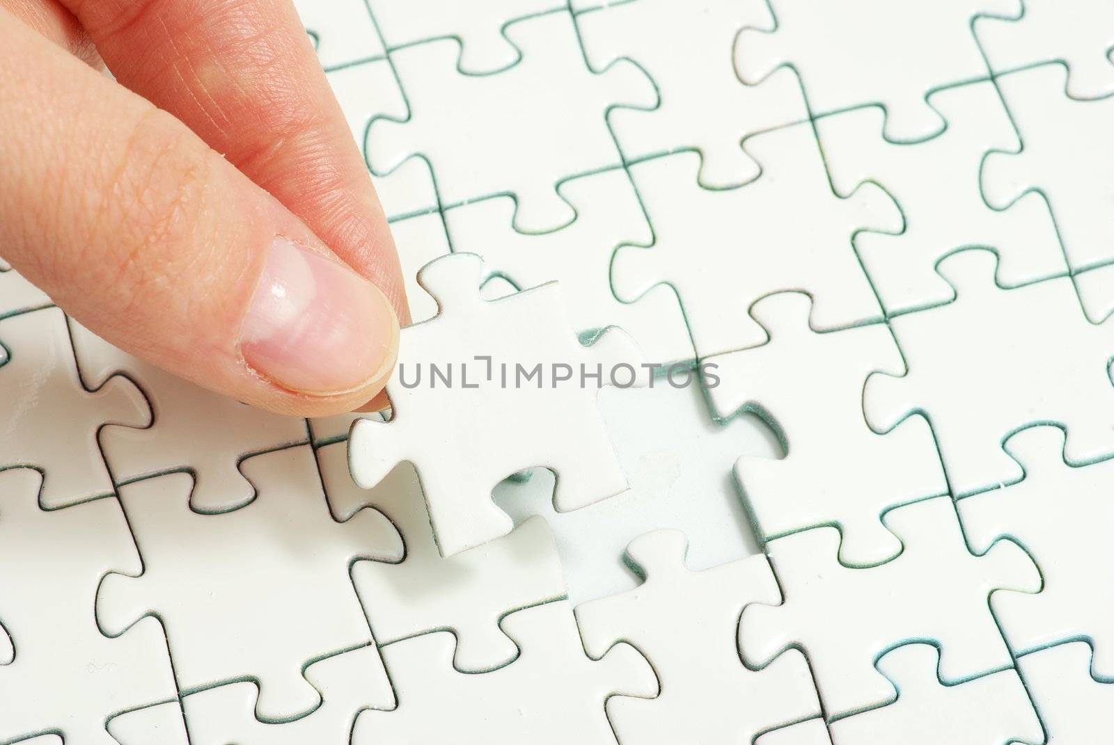 hands holding a puzzle piece . business concepts