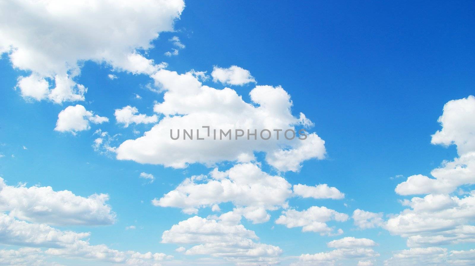 Blue sky background with tiny clouds