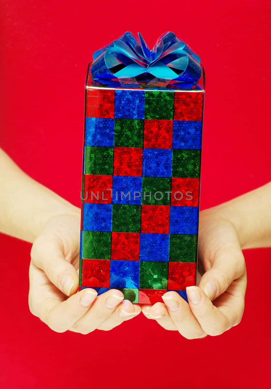 christmas gift in hands isolated on red 