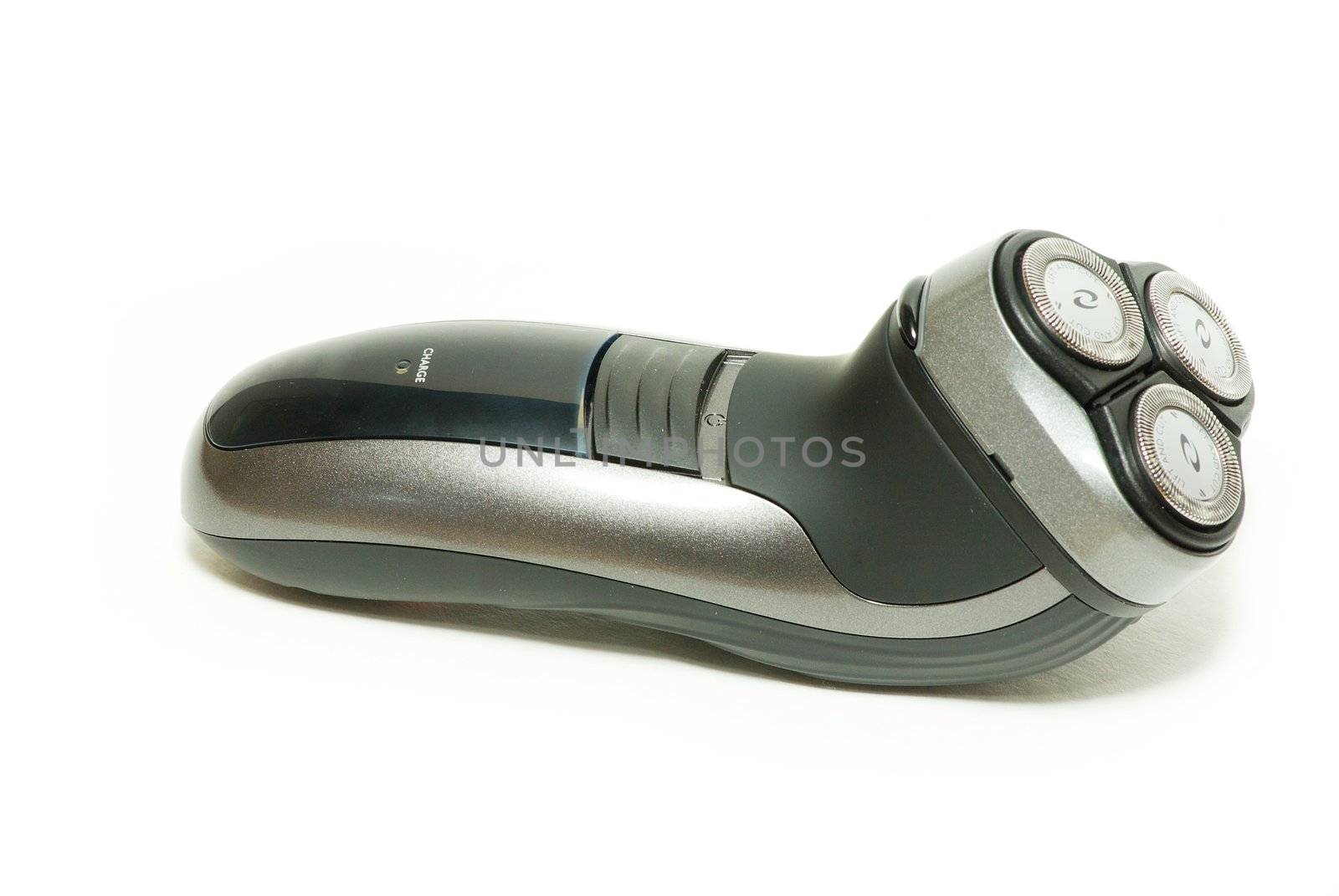 Close up on an electric razor laying sideways