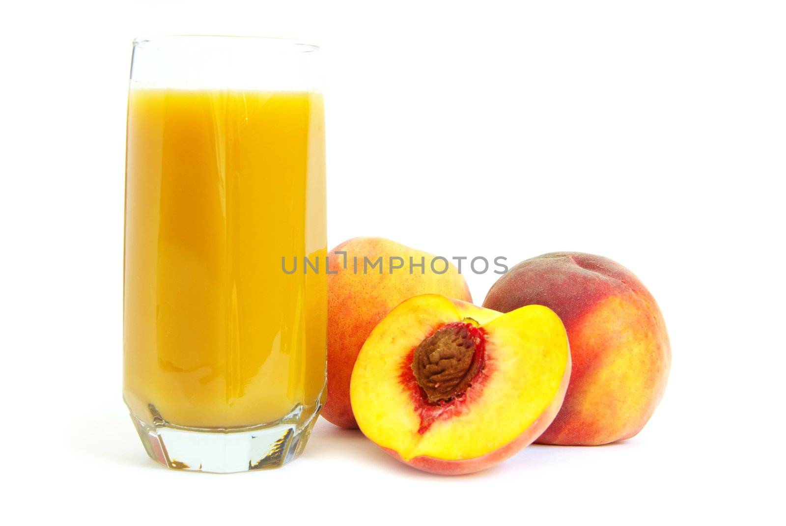 Glass with freshly made peach juice on a white background