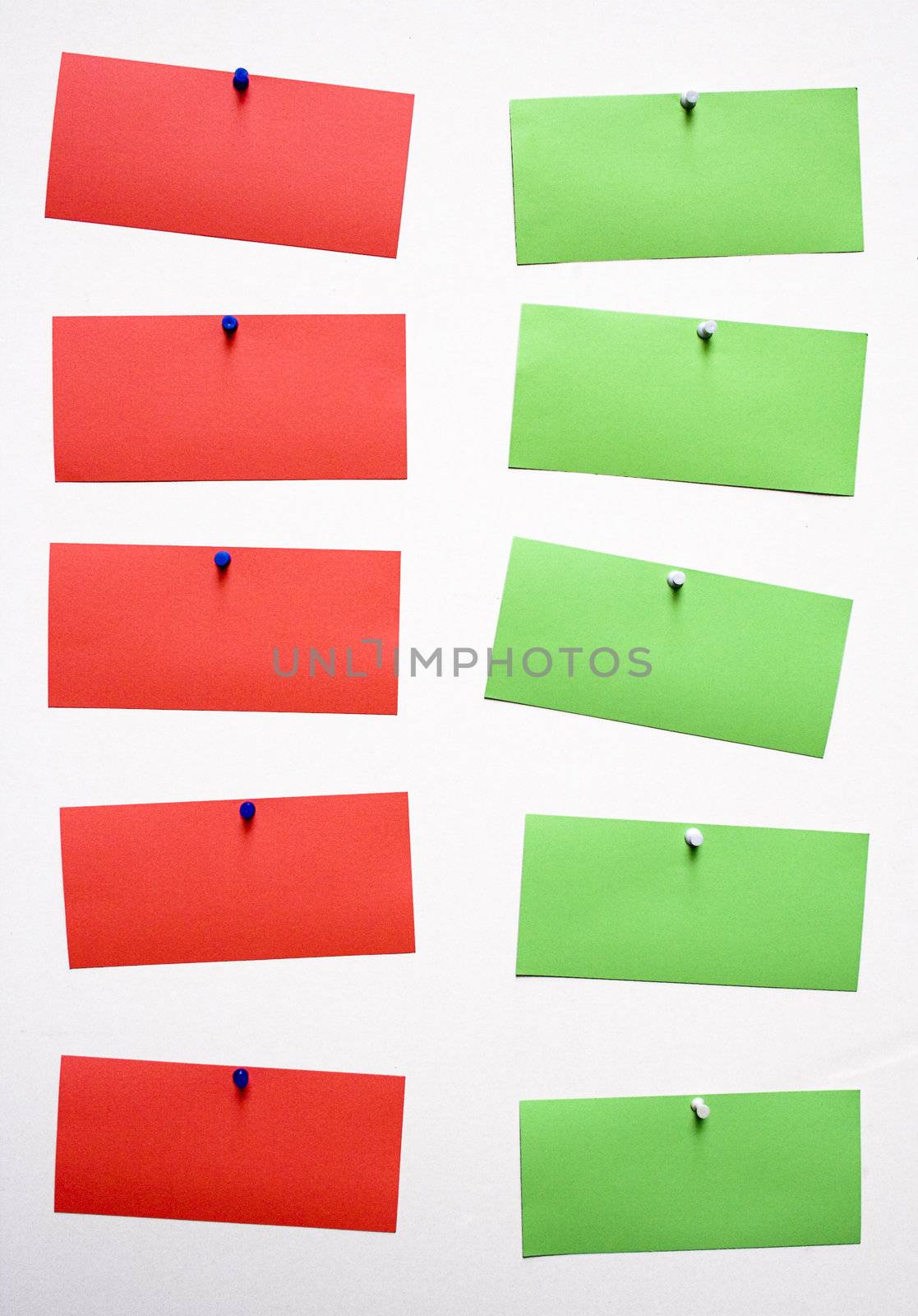 Red and green blank notes attached to a wall.