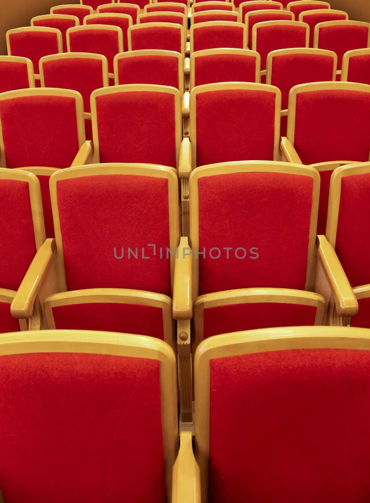 Red wooden chairs in the theater auditorium