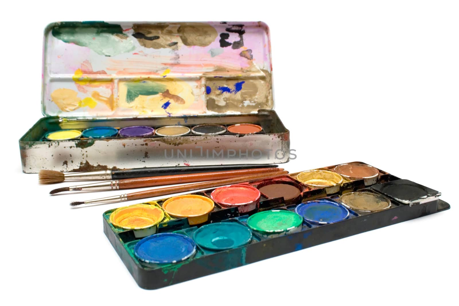 Box of watercolors and several brushes isolated on a white background.