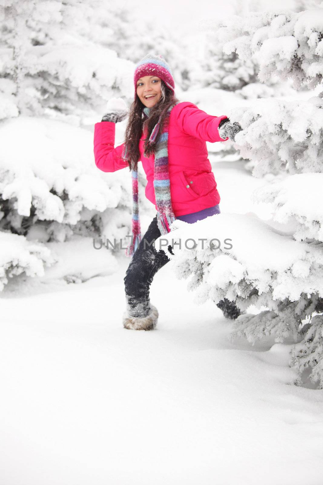 winter woman play snowballs on snow background