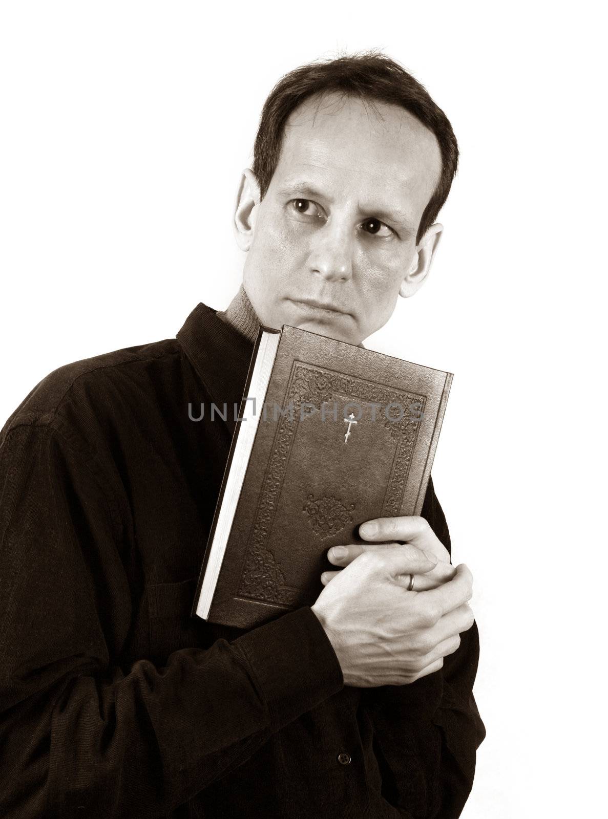 Thoughtful the man with the bible on a light background
