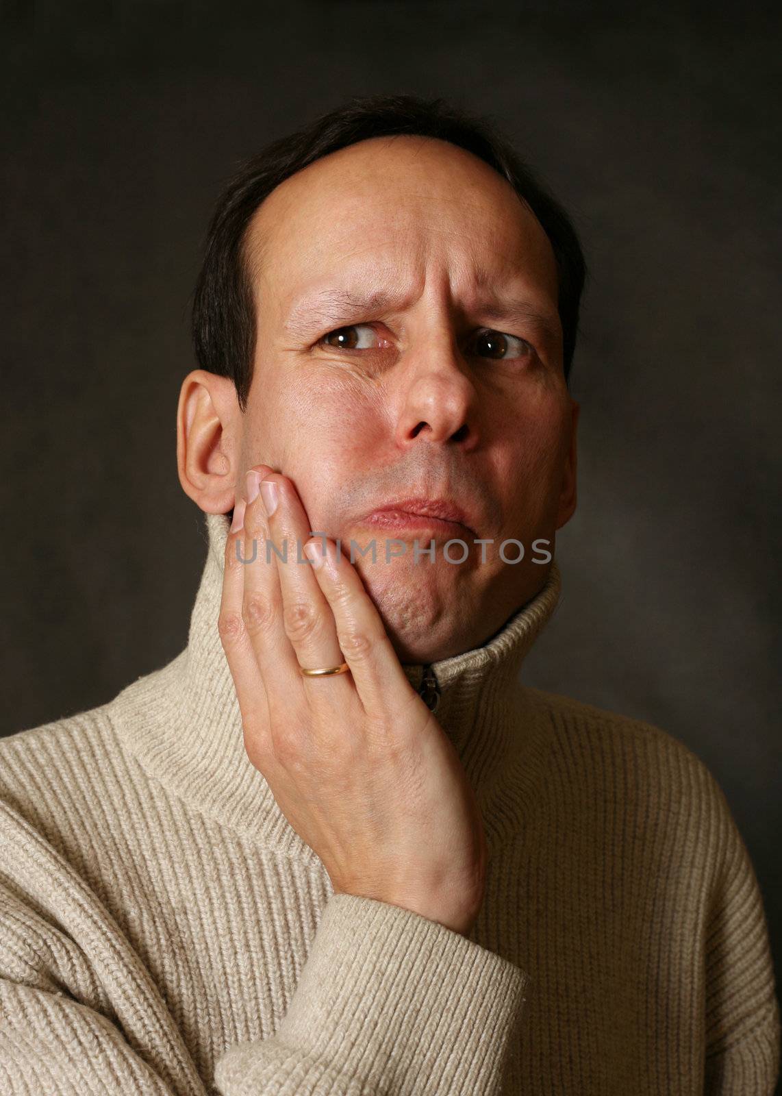 Adult man with toothache on dark background