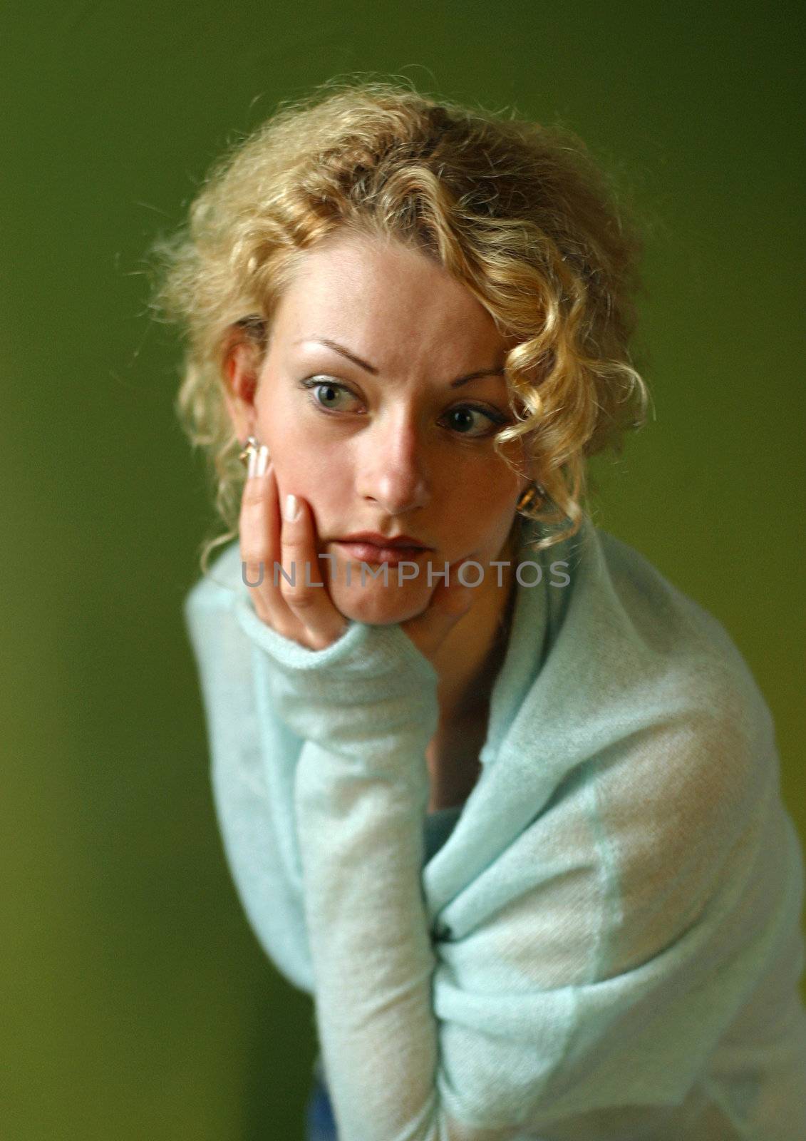 Portrait of attractive thoughtful lady, chin on her hand
