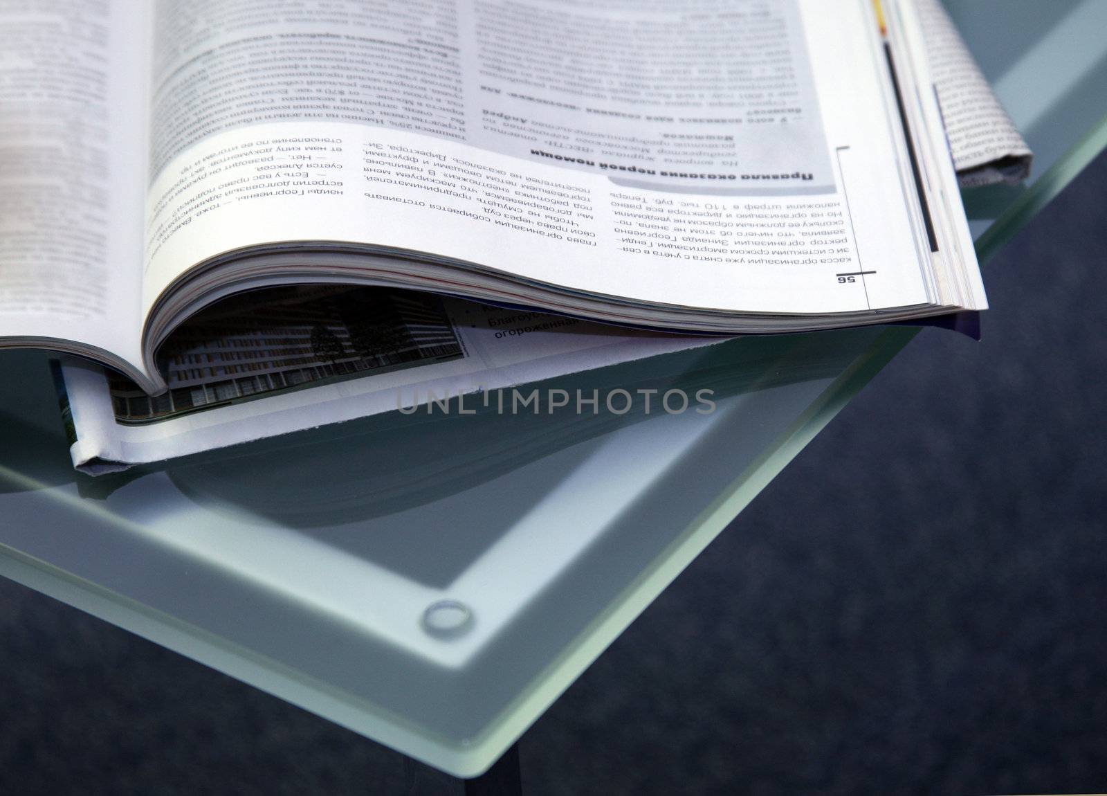 Open magazines on a glass table