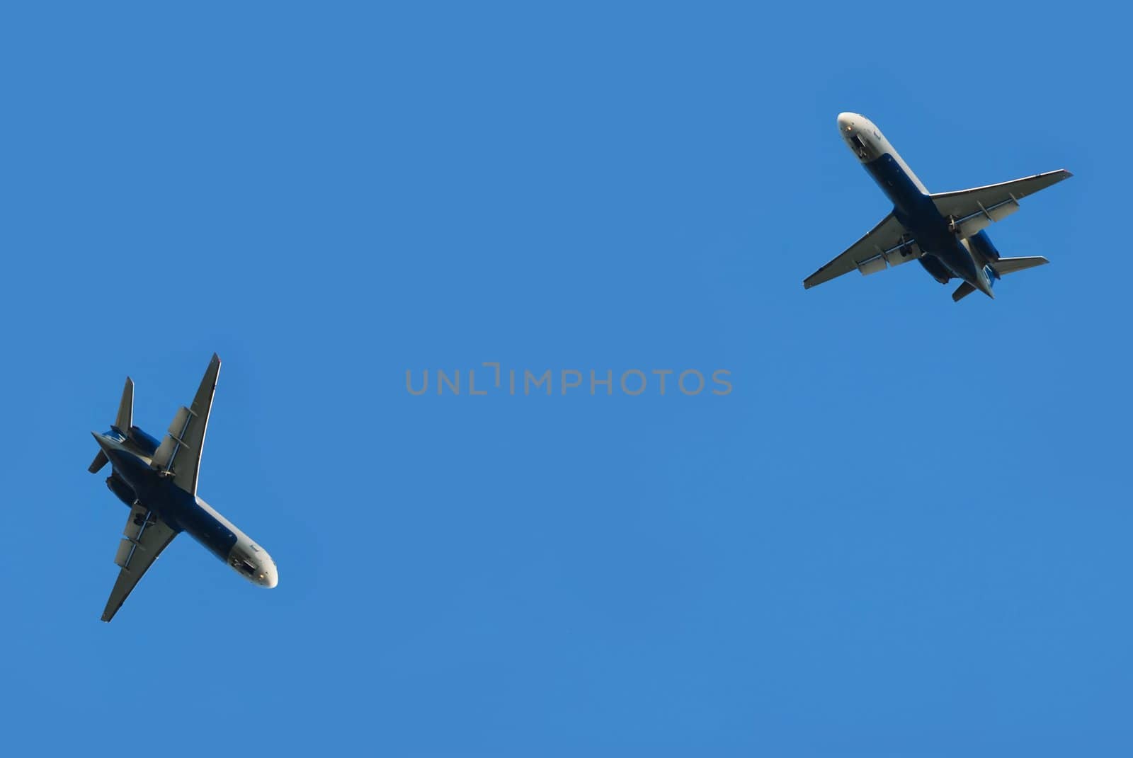 two flying planes isolated over blue sky