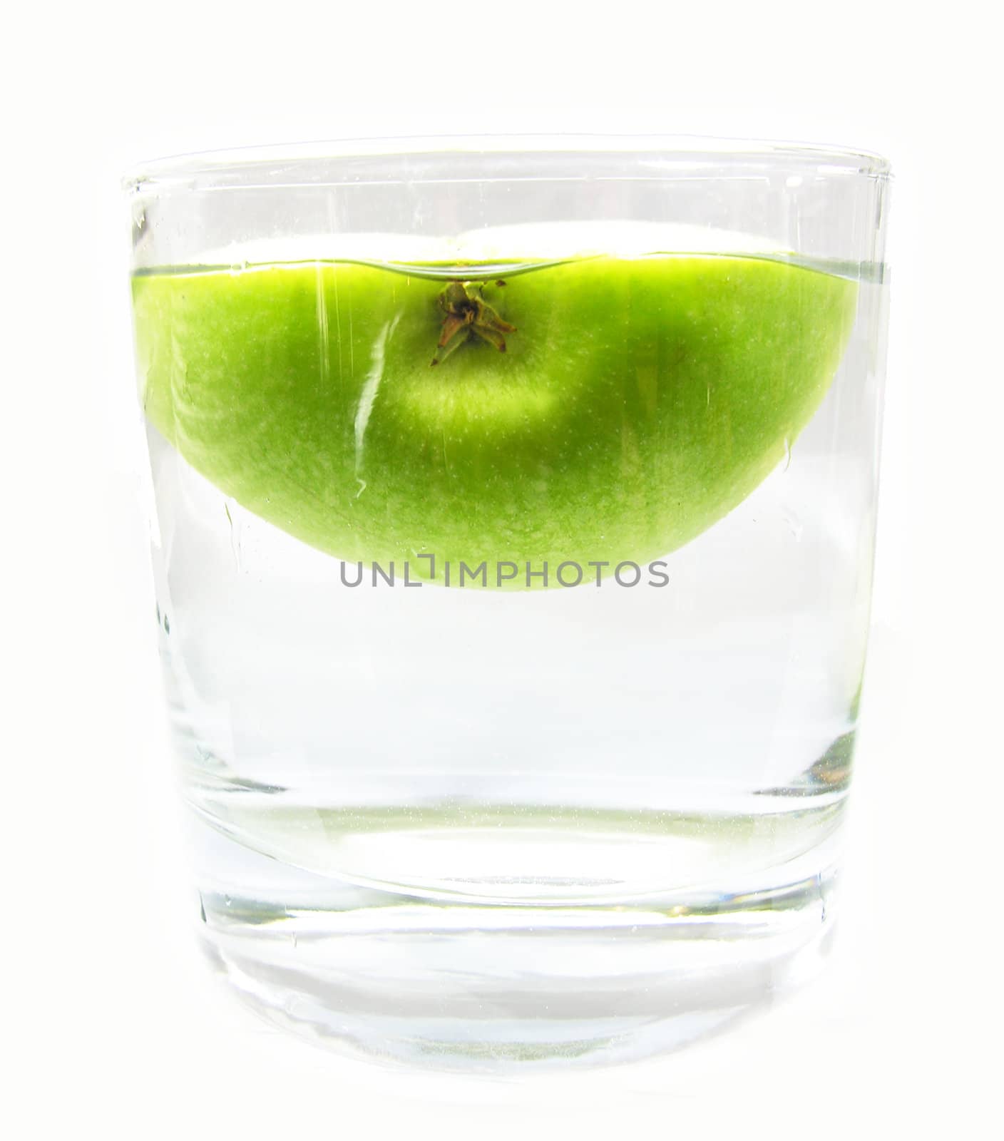 water glass with half an apple