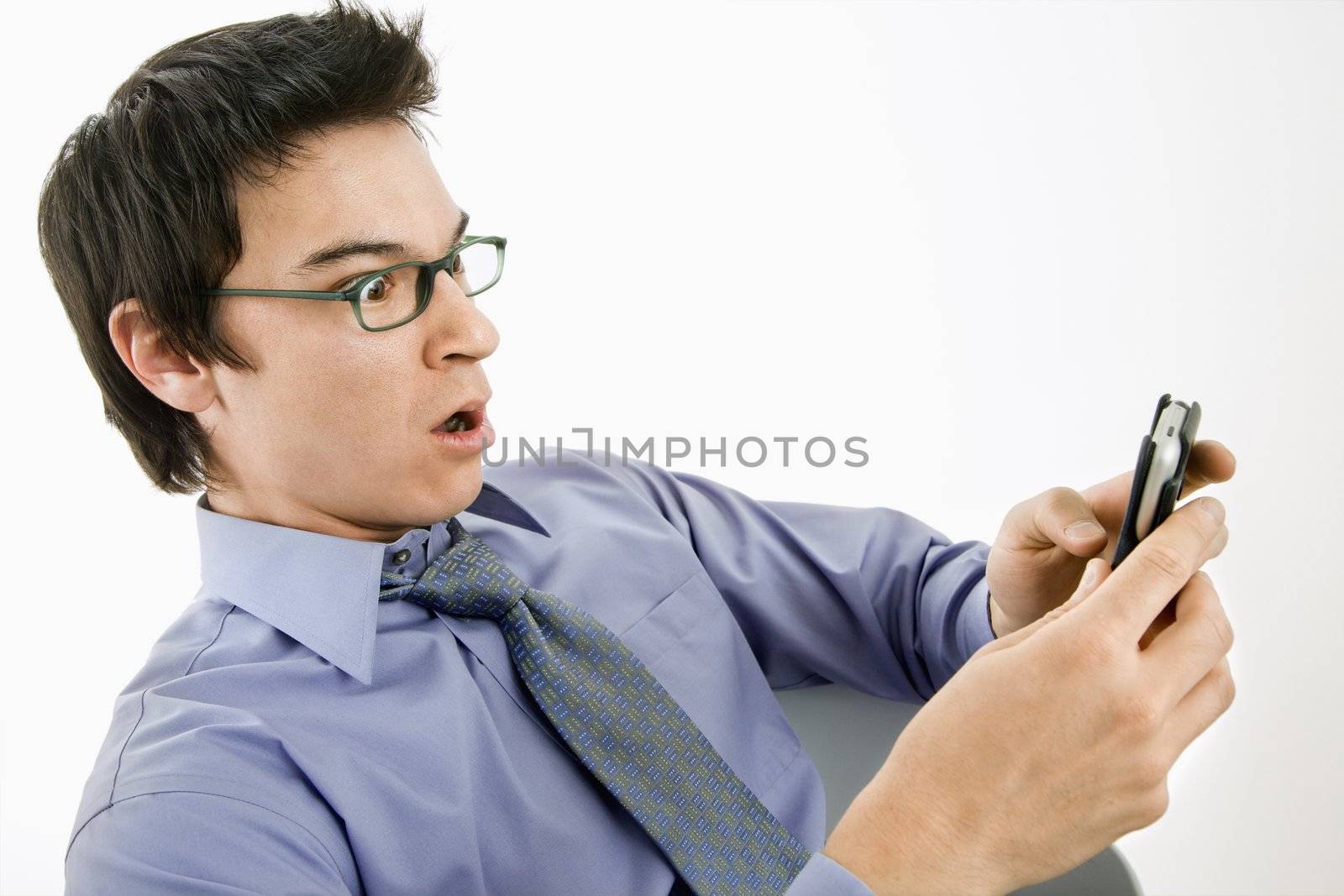 Man surprised at text message. by iofoto