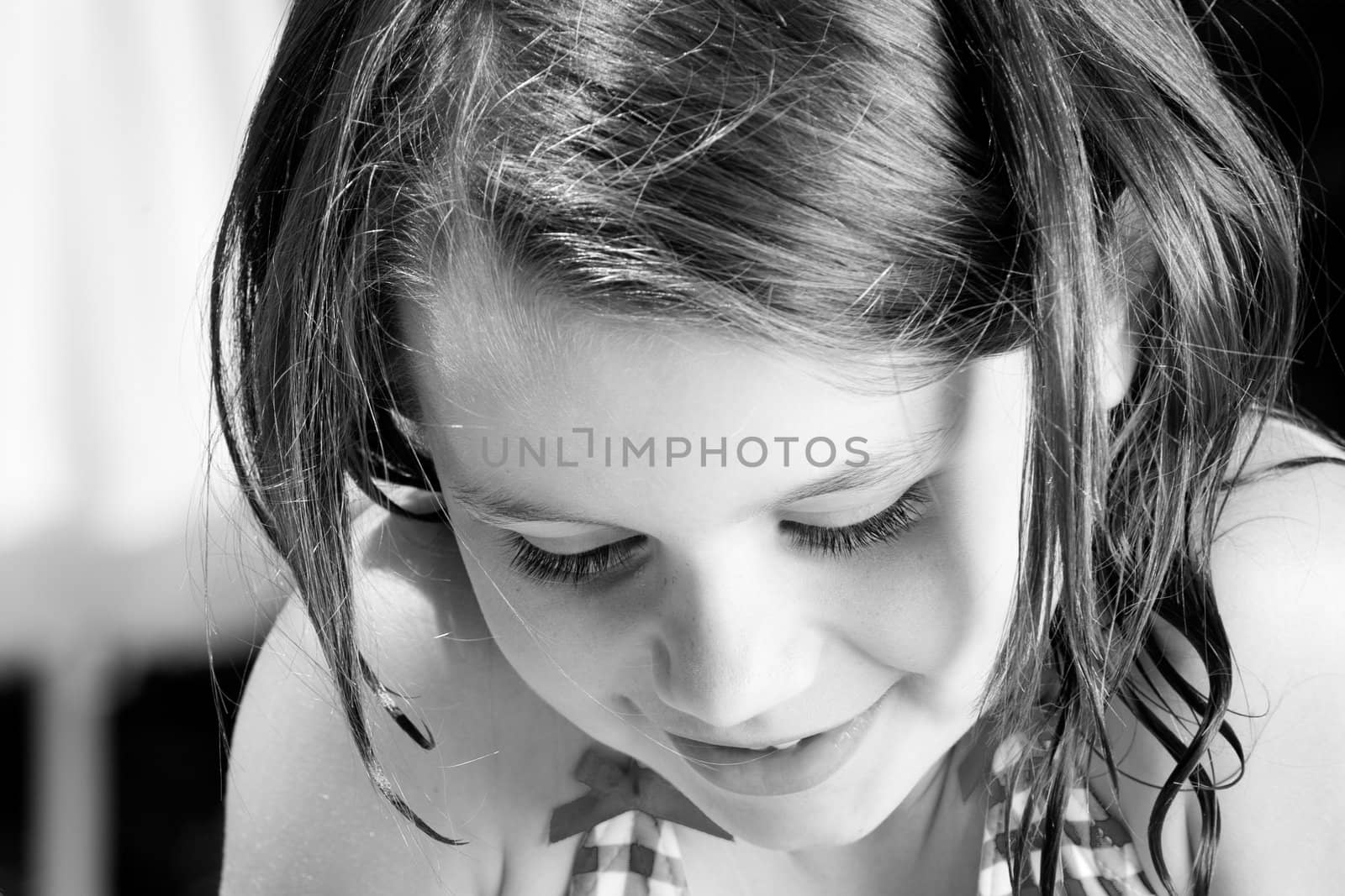 Young child enjoying the sun in and around the swimming pool