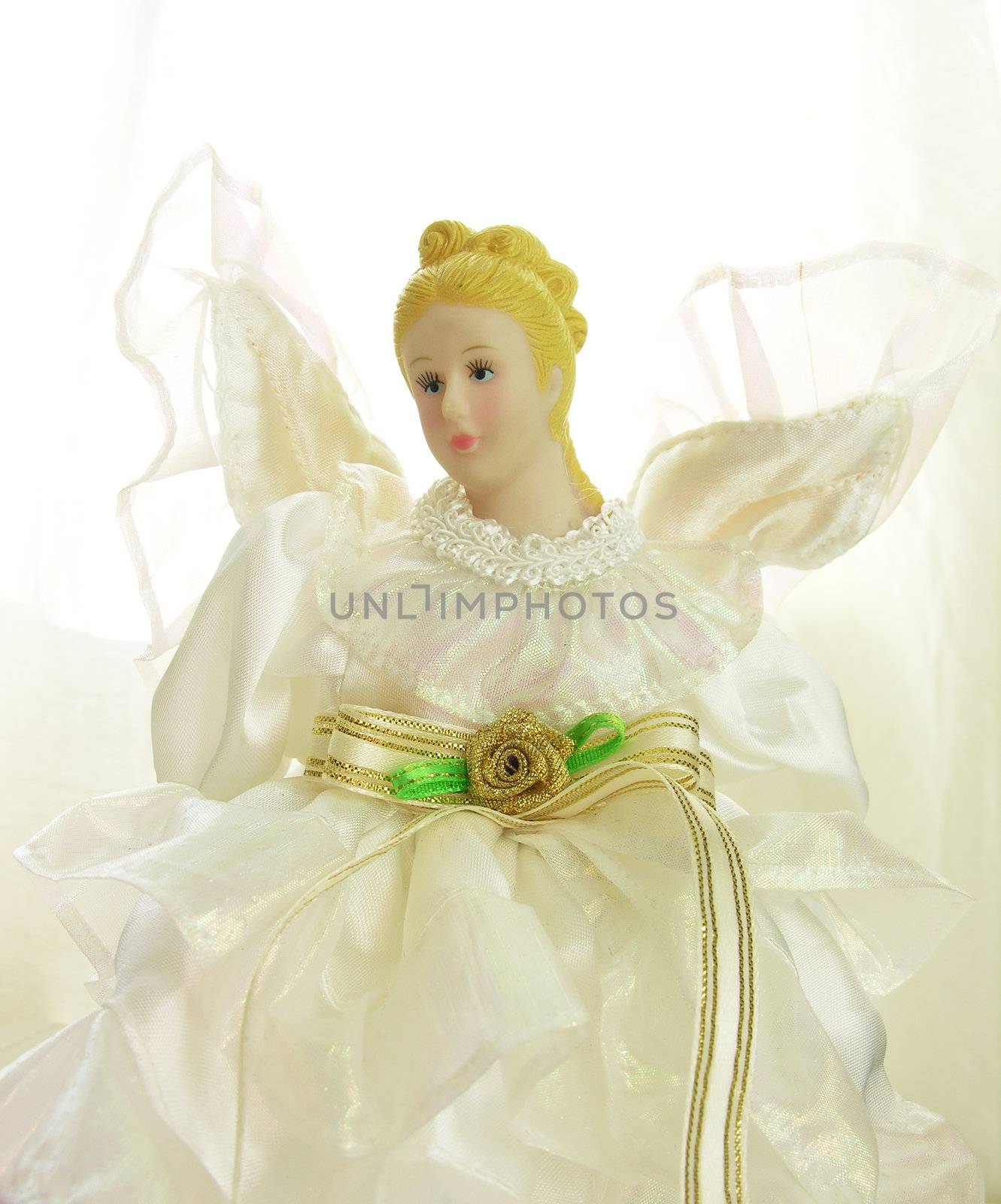 a doll with white dress isolated in white
