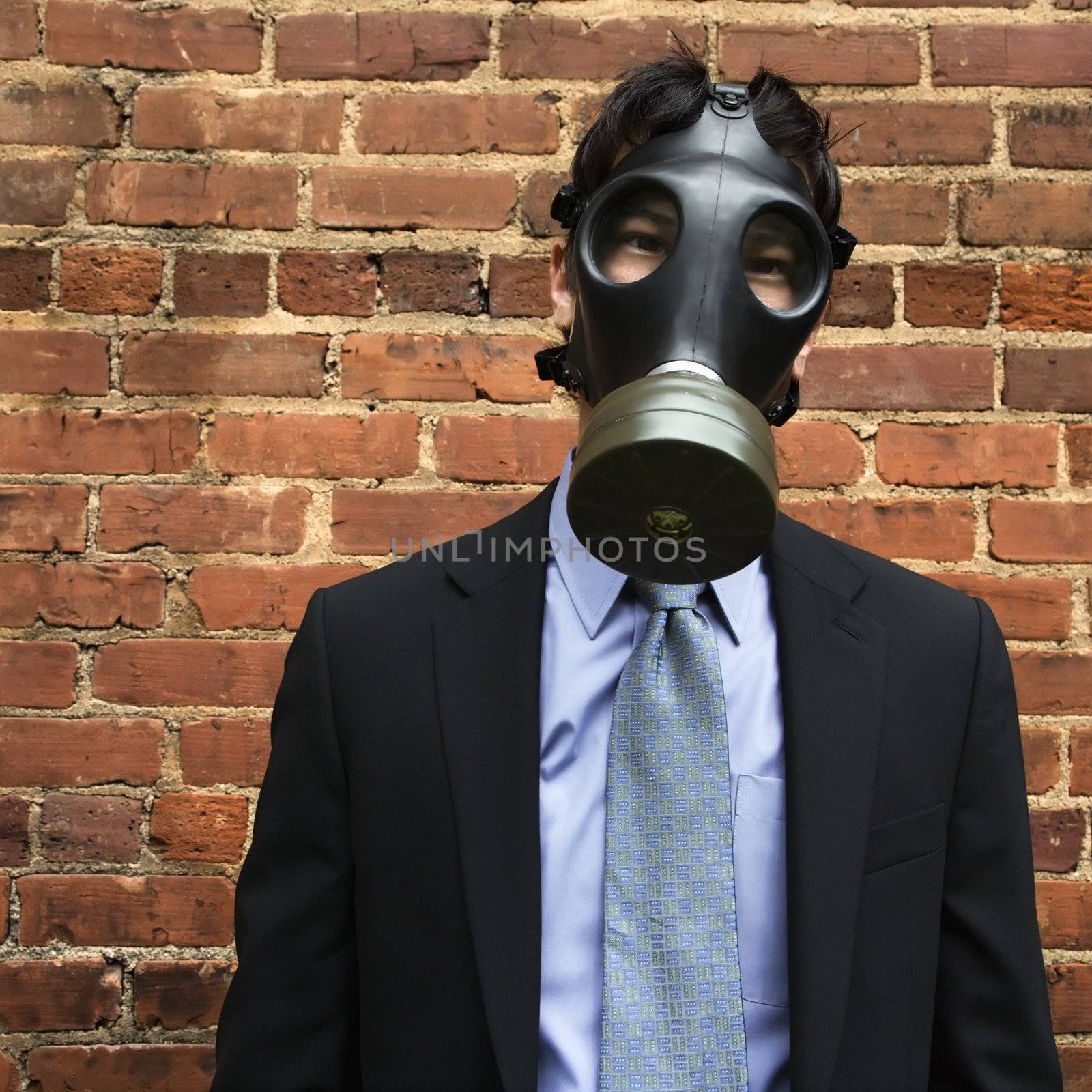 Businessman wearing gas mask. by iofoto