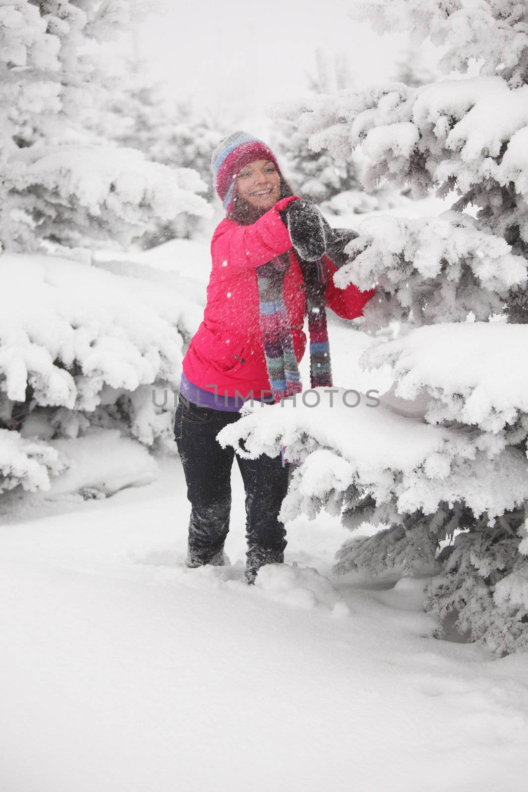 winter woman play snowballs on snow background