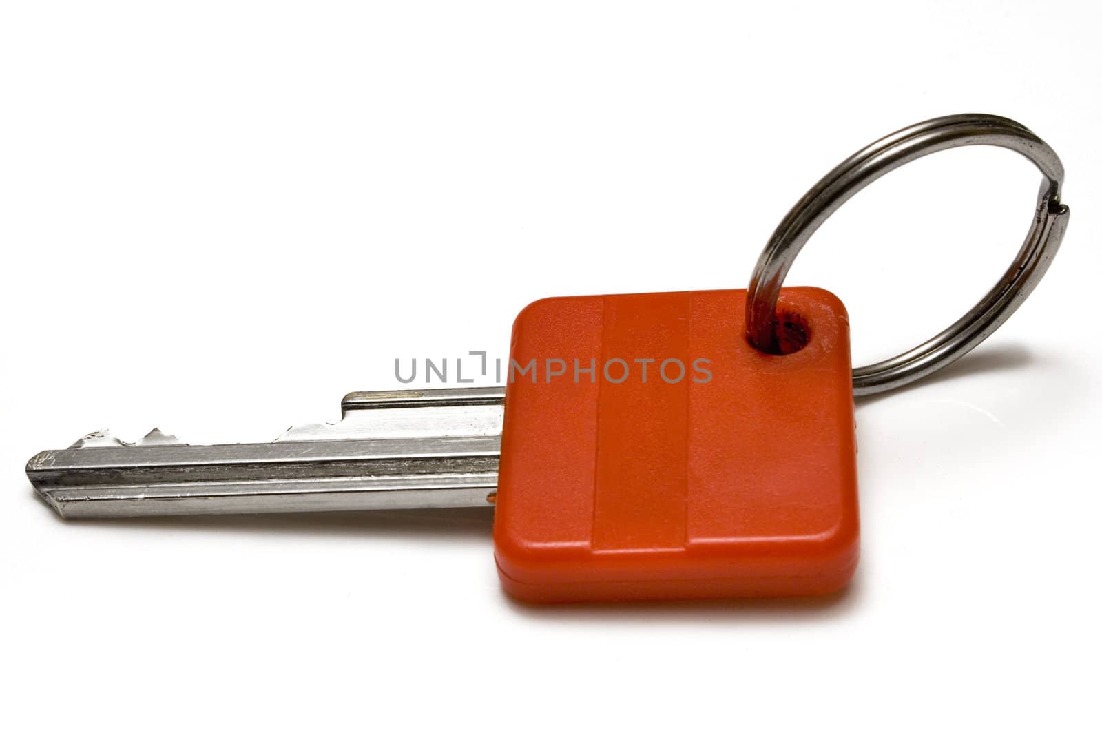 Single red key isolated on a white background.