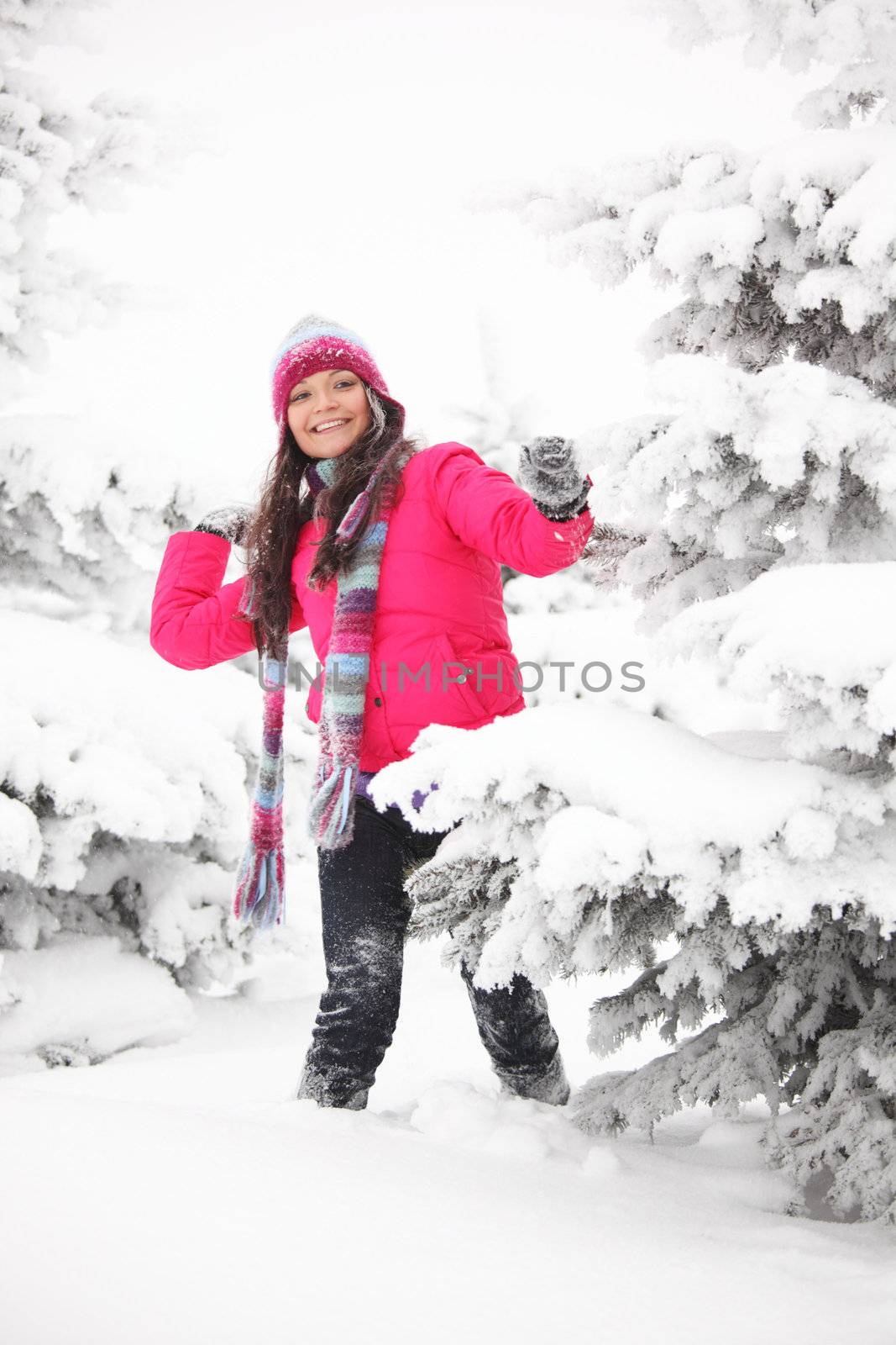 winter woman play snowballs on snow background