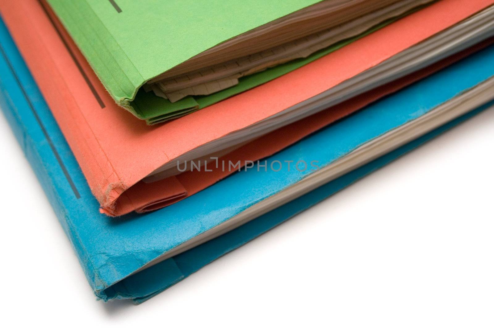 Stacked colored binders isolated on a white background.