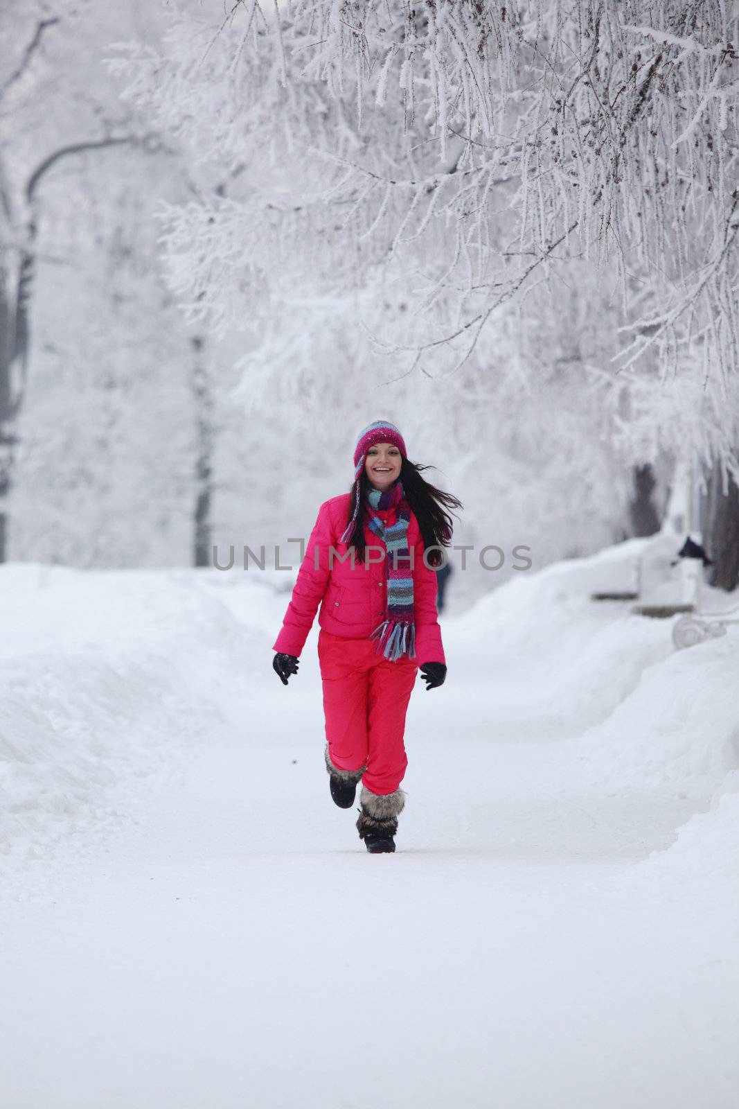 woman run in winter park very happy