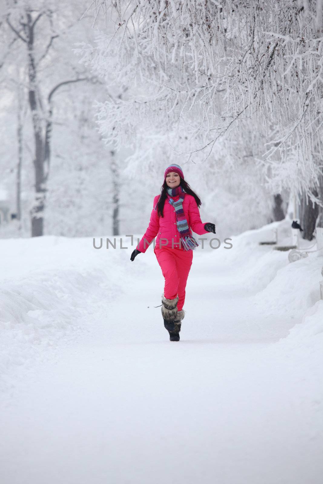 woman run in winter park very happy