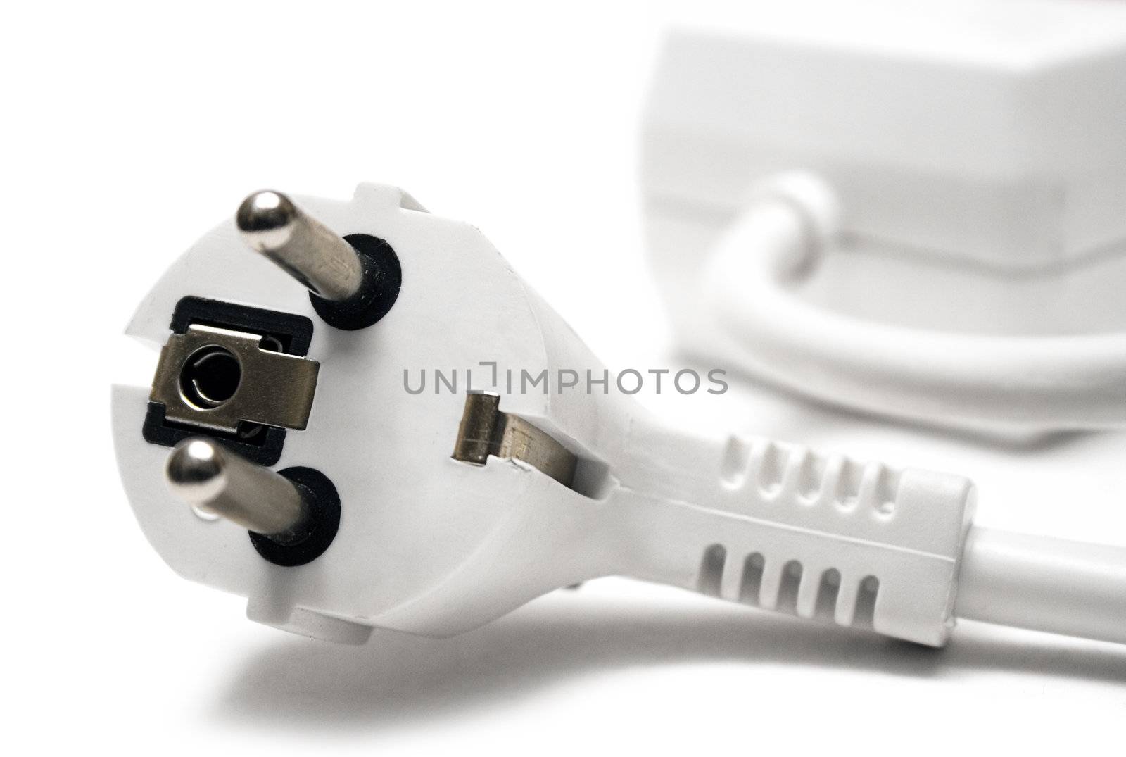 White extension cable and plug isolated on a white background.