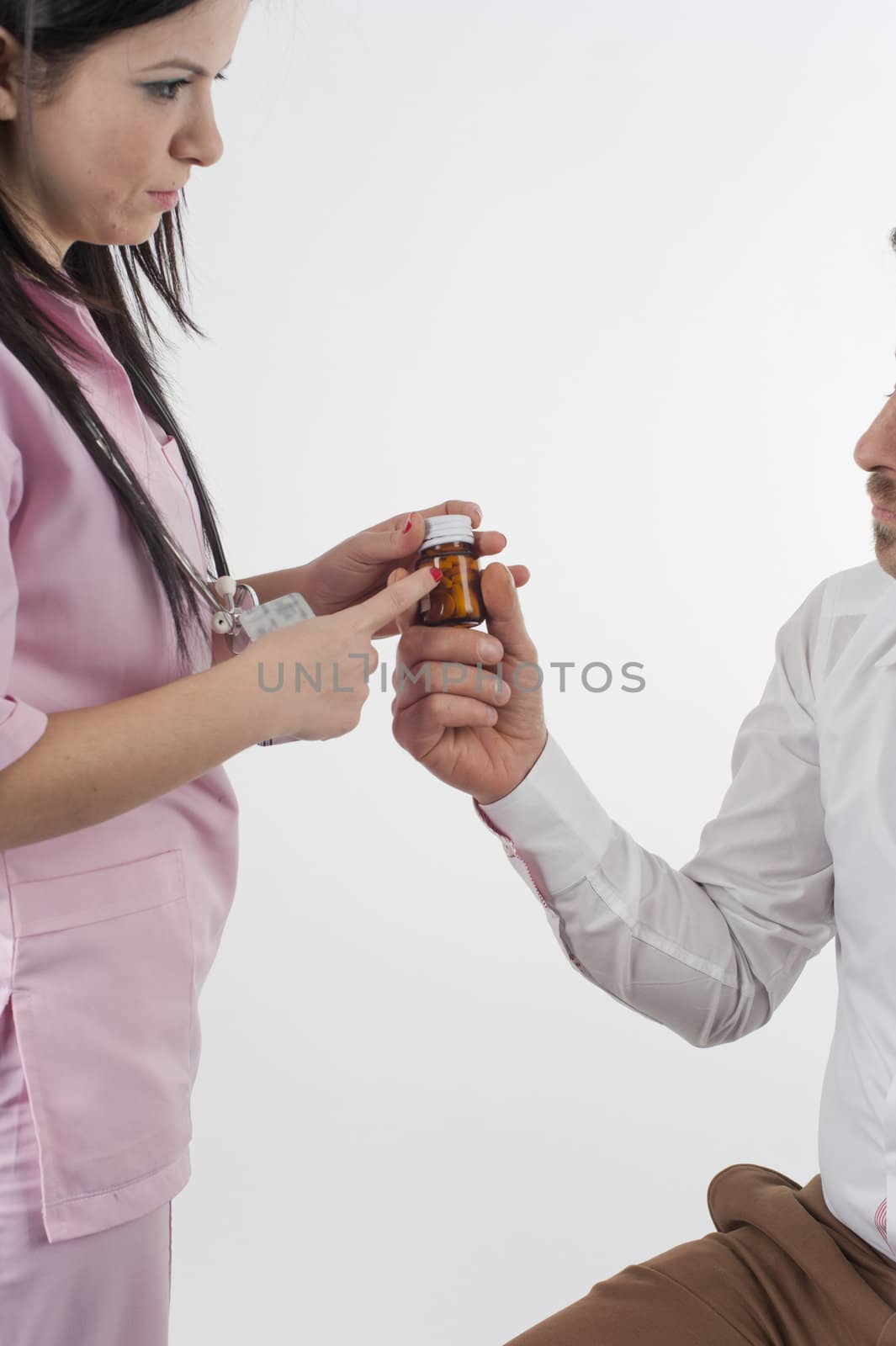 Nurse give pills to patient