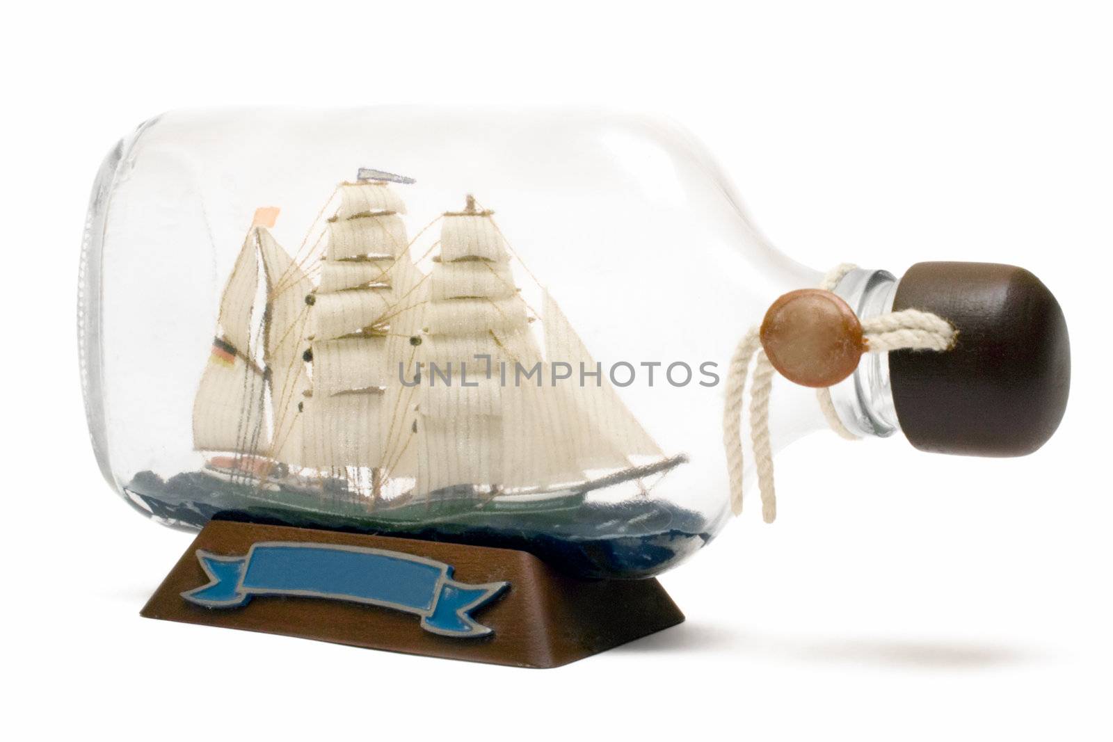 Old sailing ship model in a bottle. Isolated on a white background.