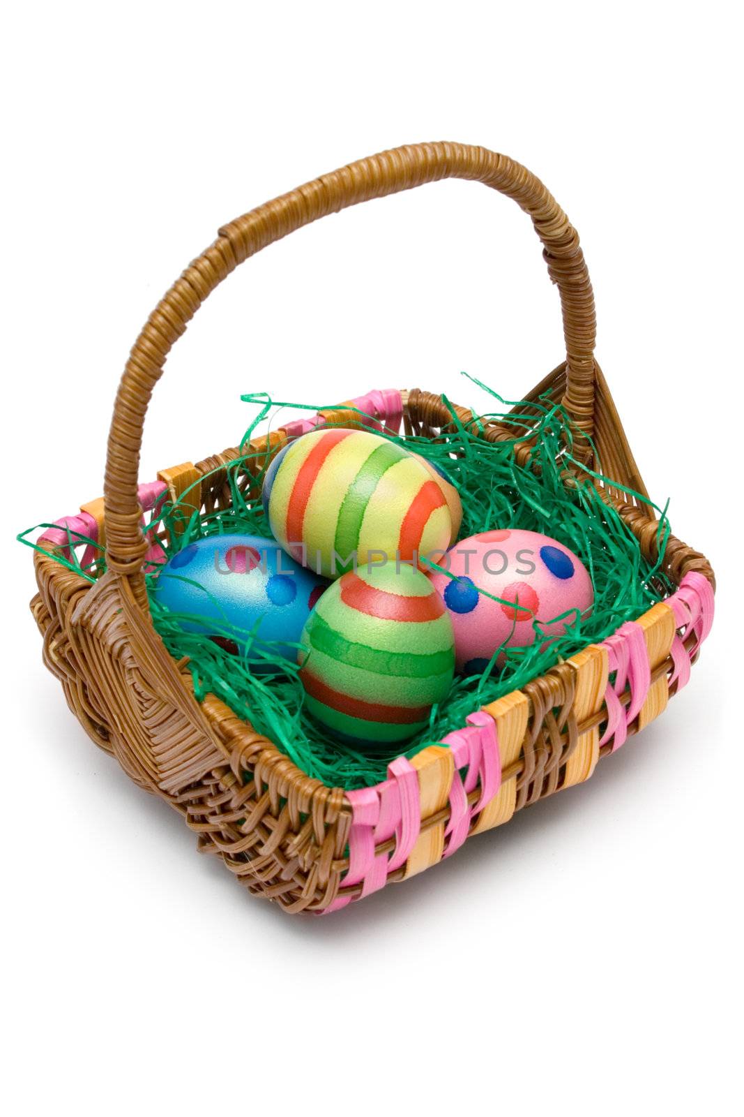 Wooden basket full of Easter eggs. Isolated on a white background.