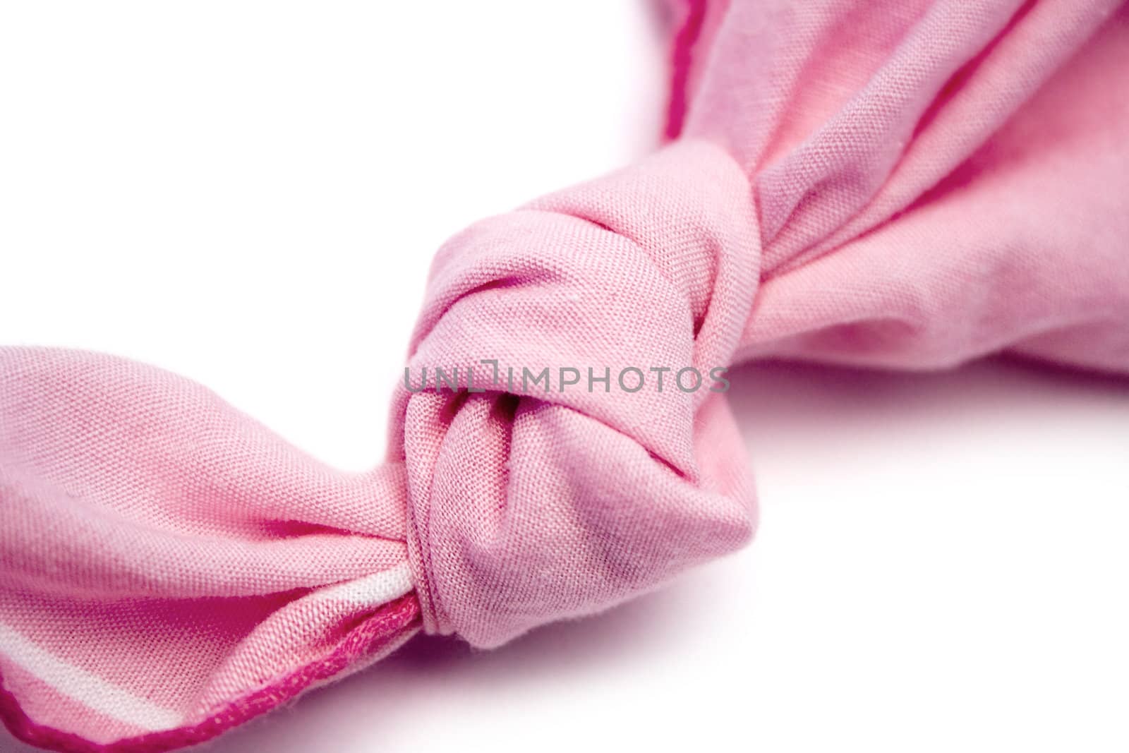 Knotted pink handkerchief isolated on a white background.