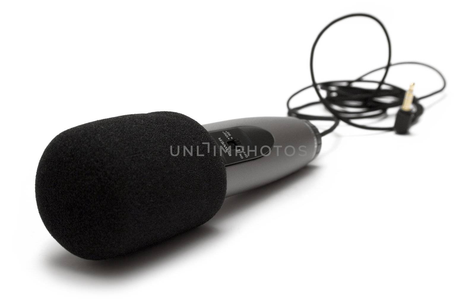 Black microphone isolated on a white background. Shallow depth of field.
