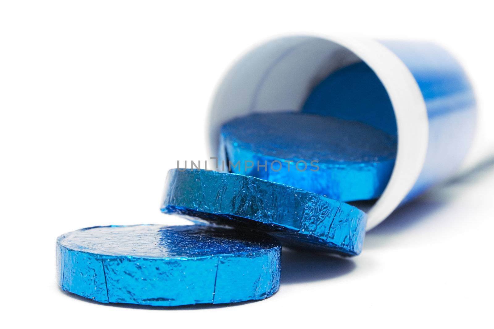 Wrapped pills in a plastic container. Isolated on a white background.