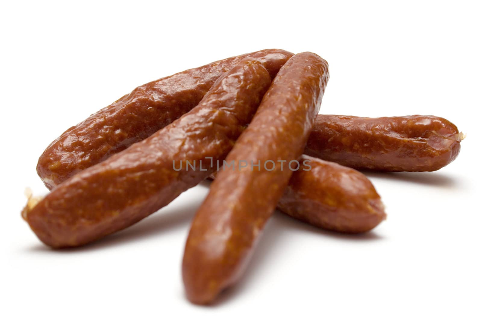 Heap of smoked sausages isolated on a white background..