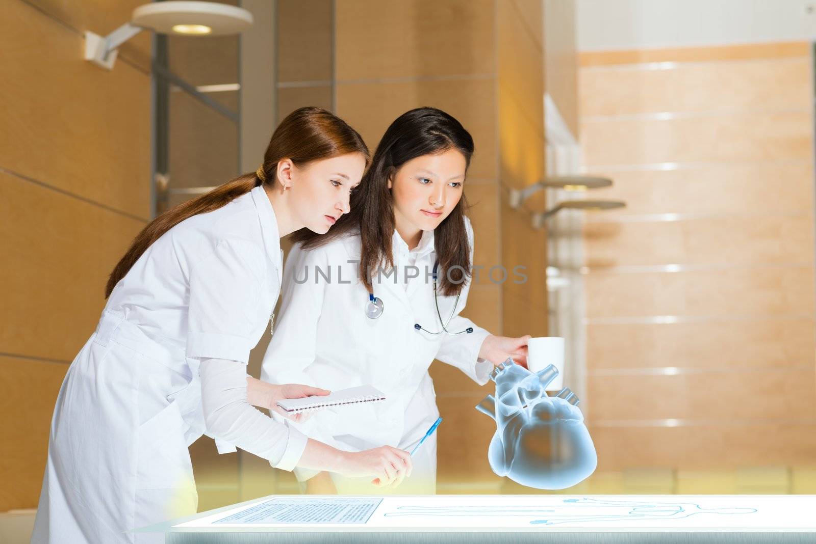 two doctors stand near glowing table discussing. projected objects on a desk