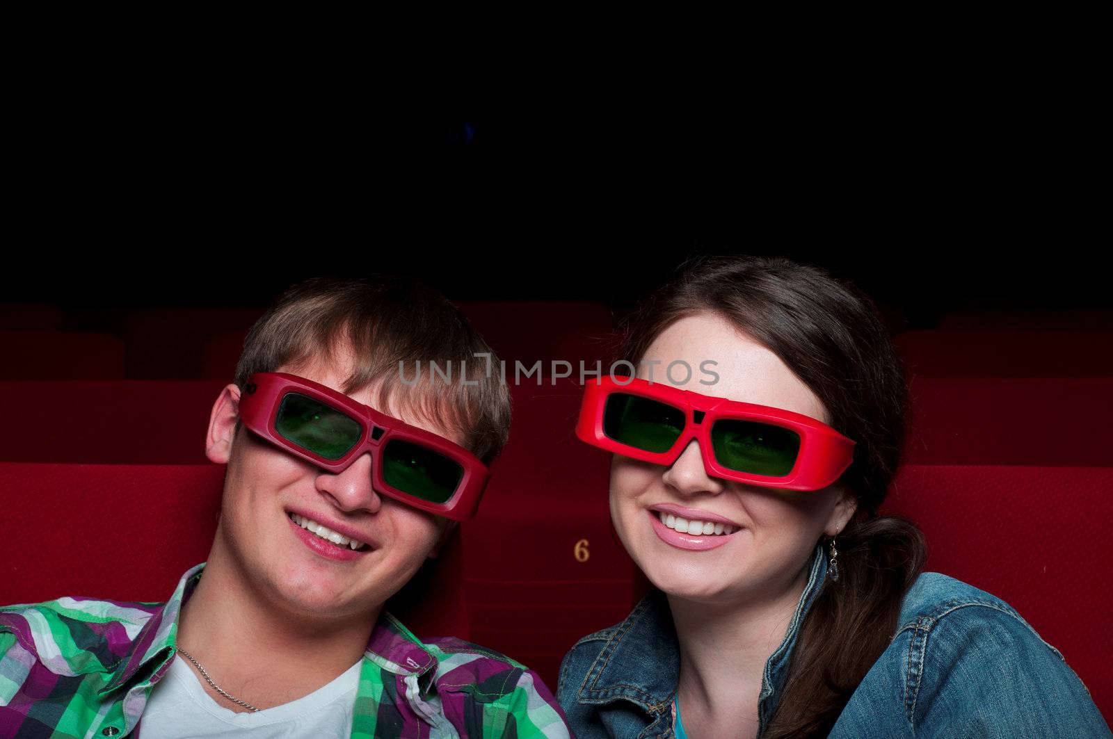 couple in a movie theater, watching a 3D movie