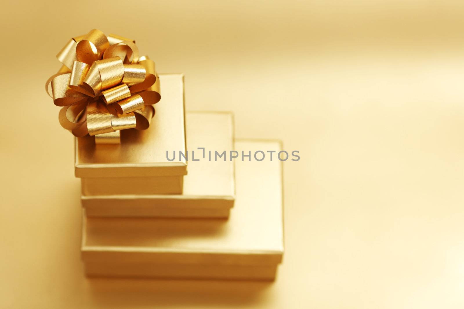 golden christmas gifts on gold background 