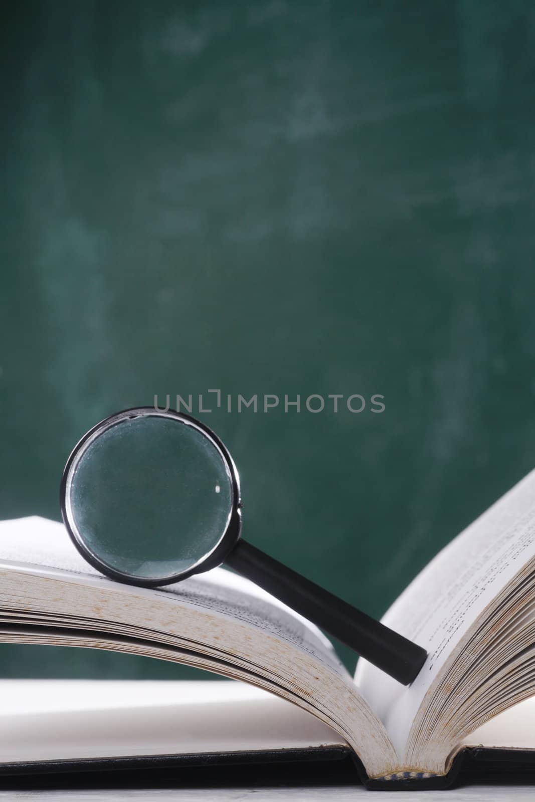magnifier resting on the open page book