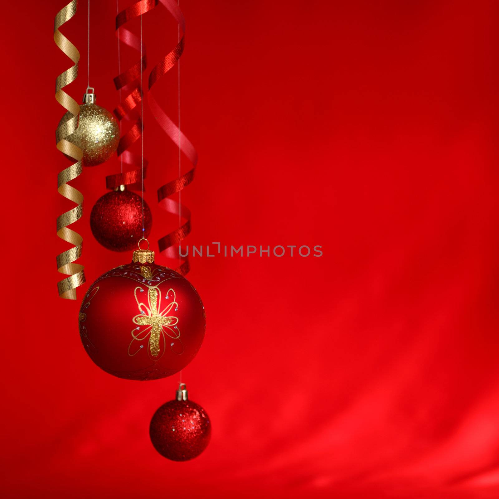  christmas balls on red satin background