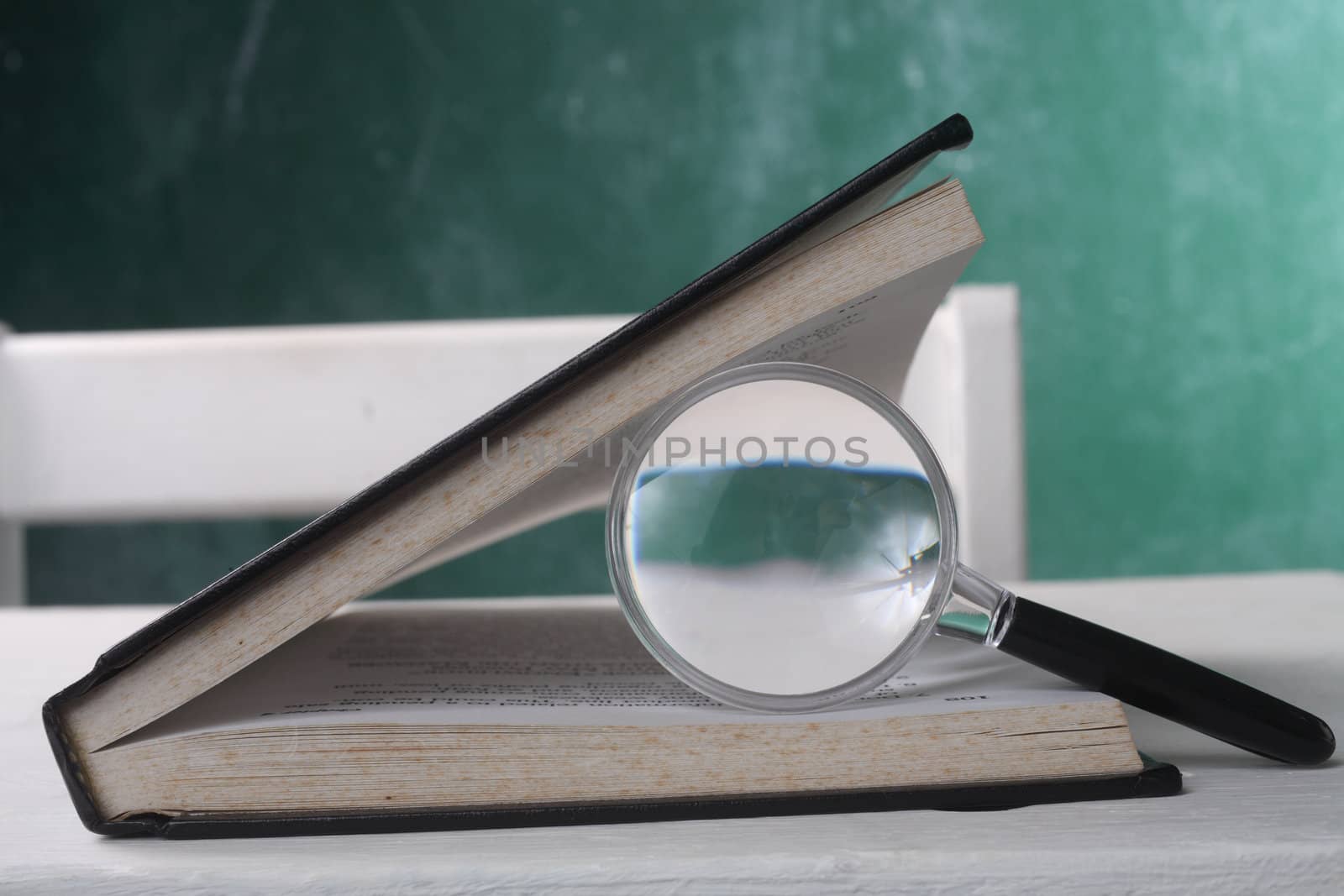 magnifier resting on the open page book