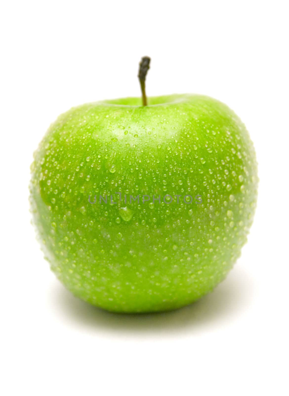Single wet granny smith apple isolated on a white background.